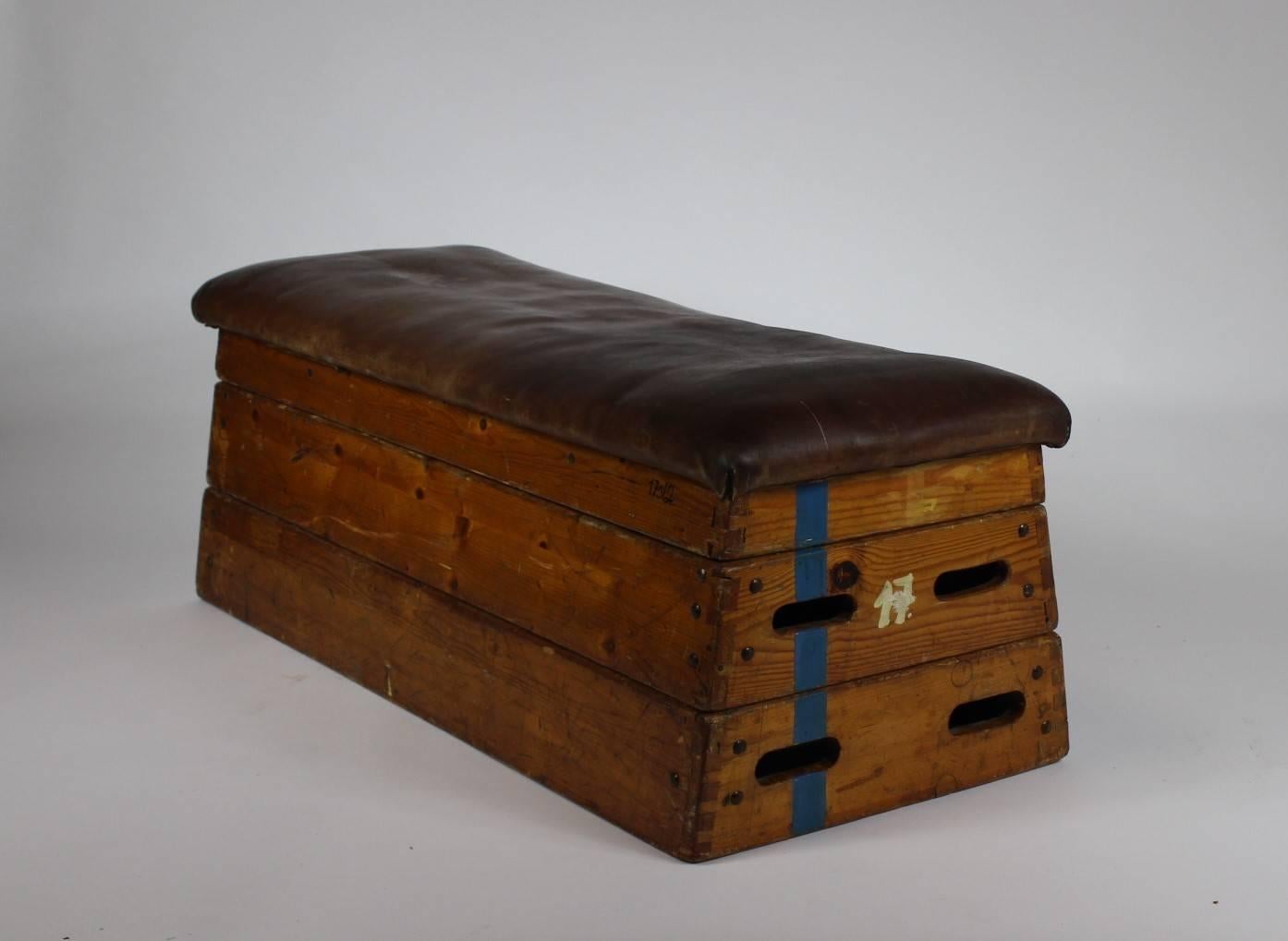 Gymnastic box or bench made in the 1950s. It is made from wood and leather. Original condition with patina.