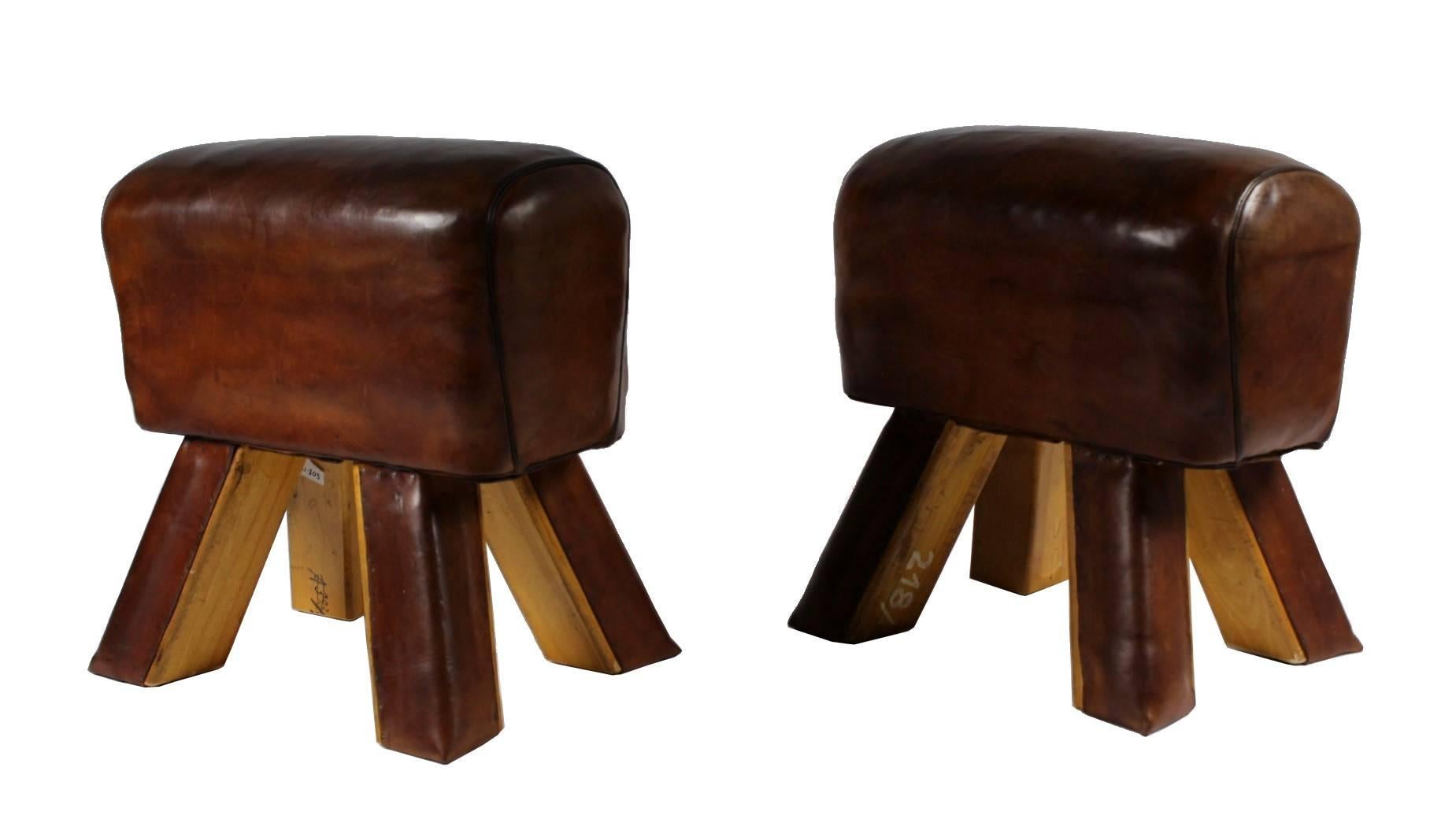 Pair of leather gym stools from the 1930s. They are in good original condition.