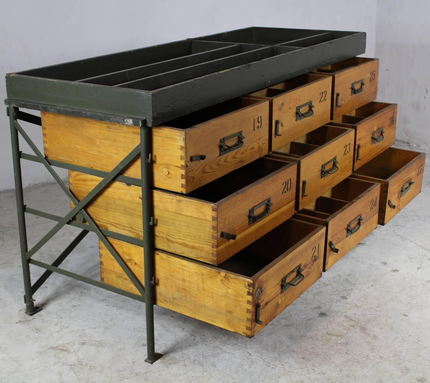 Original primitive industrial chest of drawers from the 1950s. Originally used by Czechoslovak army as a part of a service truck Praga V3S. Metal frame, nine solid wood drawers.
