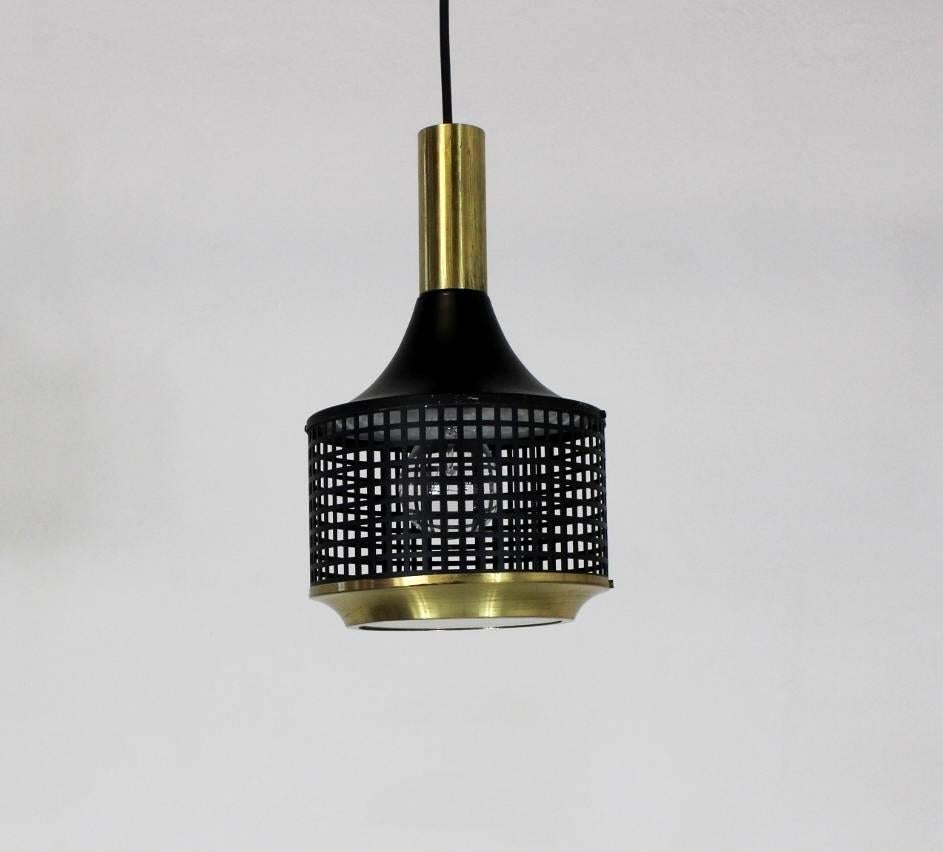 Pendant light made in the 1970s in Bratislava, Slovakia. The light is made from brass and black lacquered metal. Manufactured by Lubid.