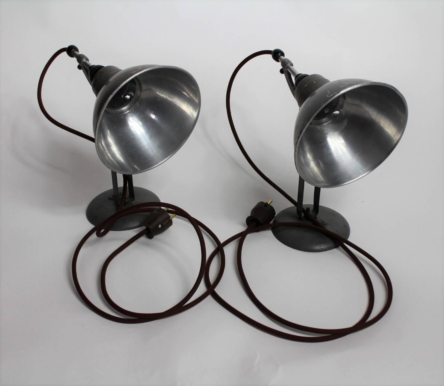 Pair of small Industrial table lamps manufactured in the 1930s in Switzerland by Bag. The lamps are made from a steel base and adjustable aluminium shades (diameter 7”). Great patina, new electrical installation.