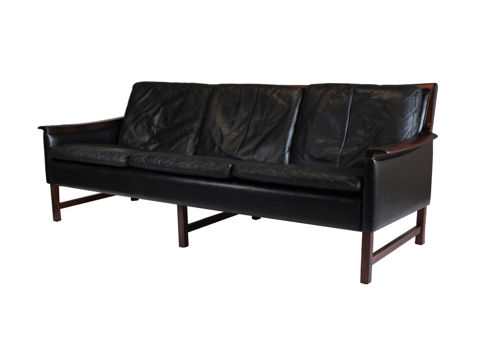 High quality black leather sofa Minerva, designed by Norwegian designer Torbjørn Afdal for Bruksbo. Material is rosewood and perfectly worn leather. The sofa is in excellent vintage condition.