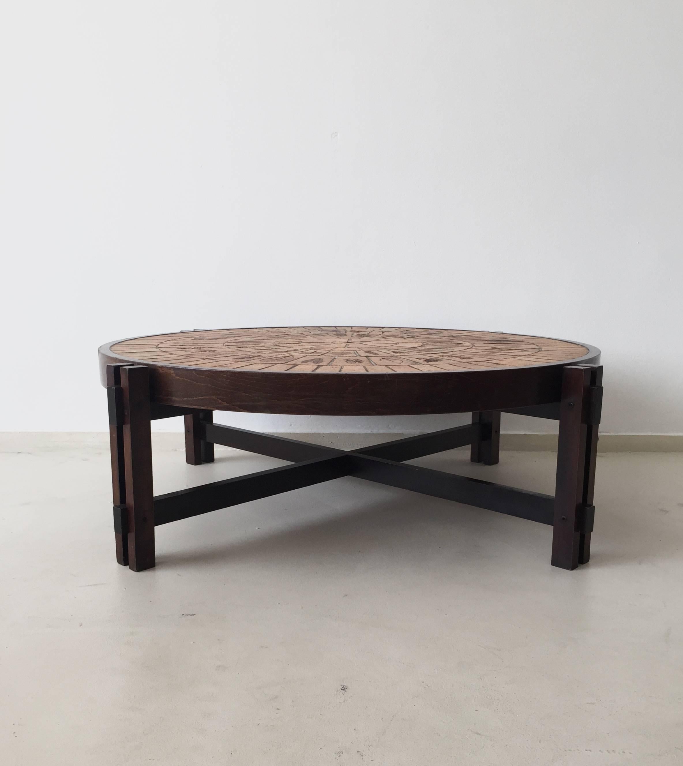 This coffee table was designed by Roger Capron during the 1960s and produced by the French manufacturer Atelier Capron. It features ceramic tiles on a wooden base. The table remains in a good vintage condition, with small signs of age and use.