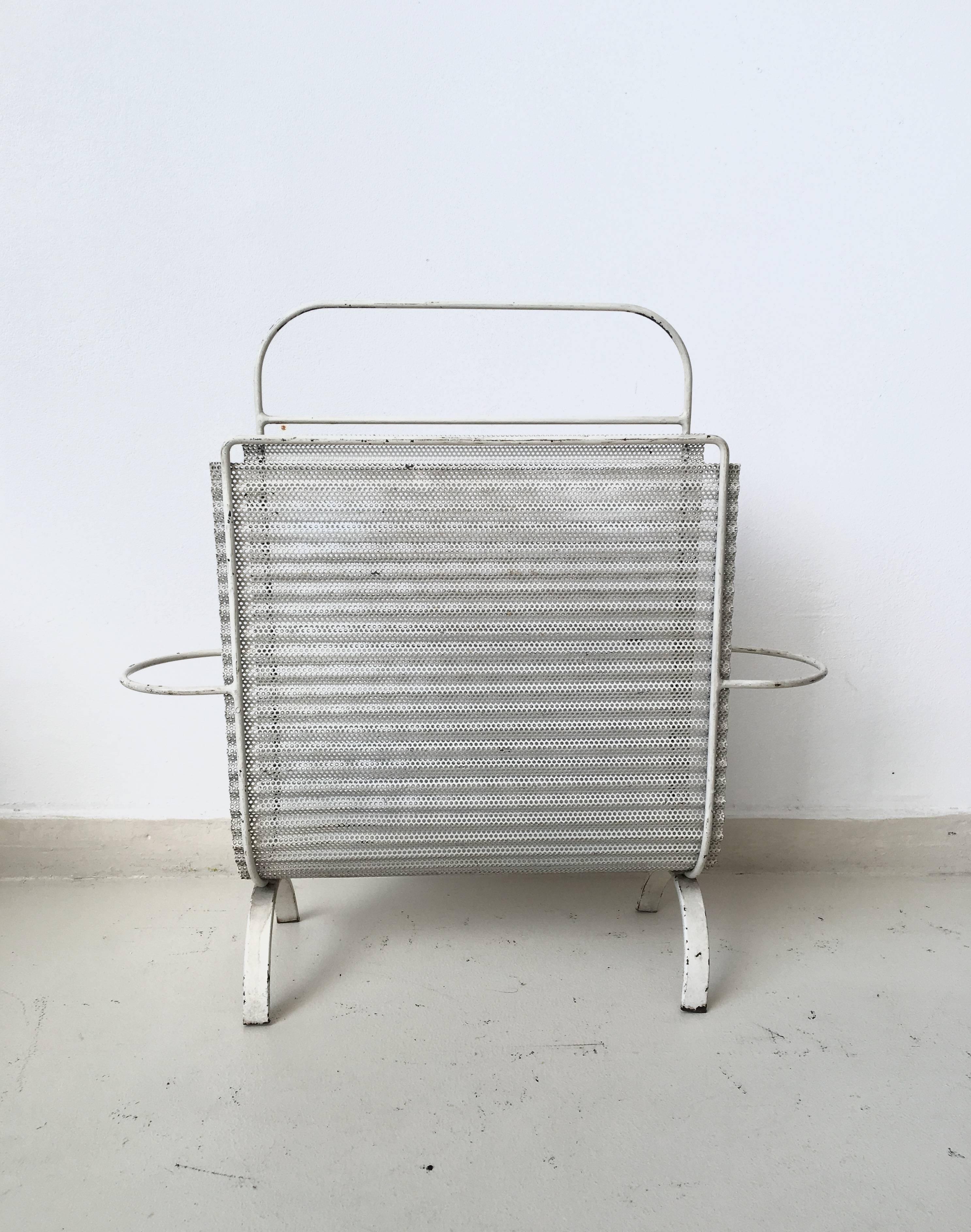 Beautiful White Magazine Rack, Holder with typical perforated Metal base. The piece remains in a good vintage condition with wear consistent with age and use.
 