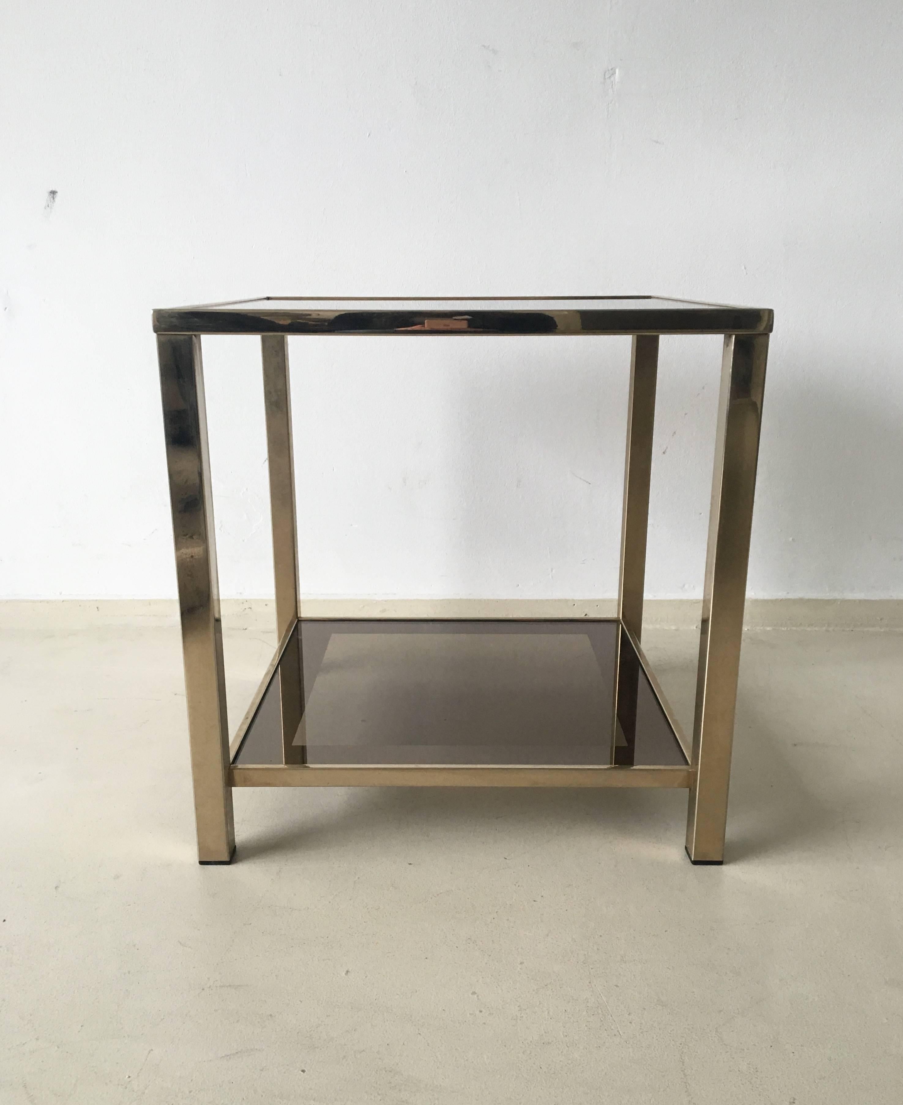 This exclusive two-tiered table was designed with a gold-plated metal frame and wonderful mirrored borders in the glass.
It is in a very good condition with minor signs of age and use. The table is marked with a certificate. ON SALE!