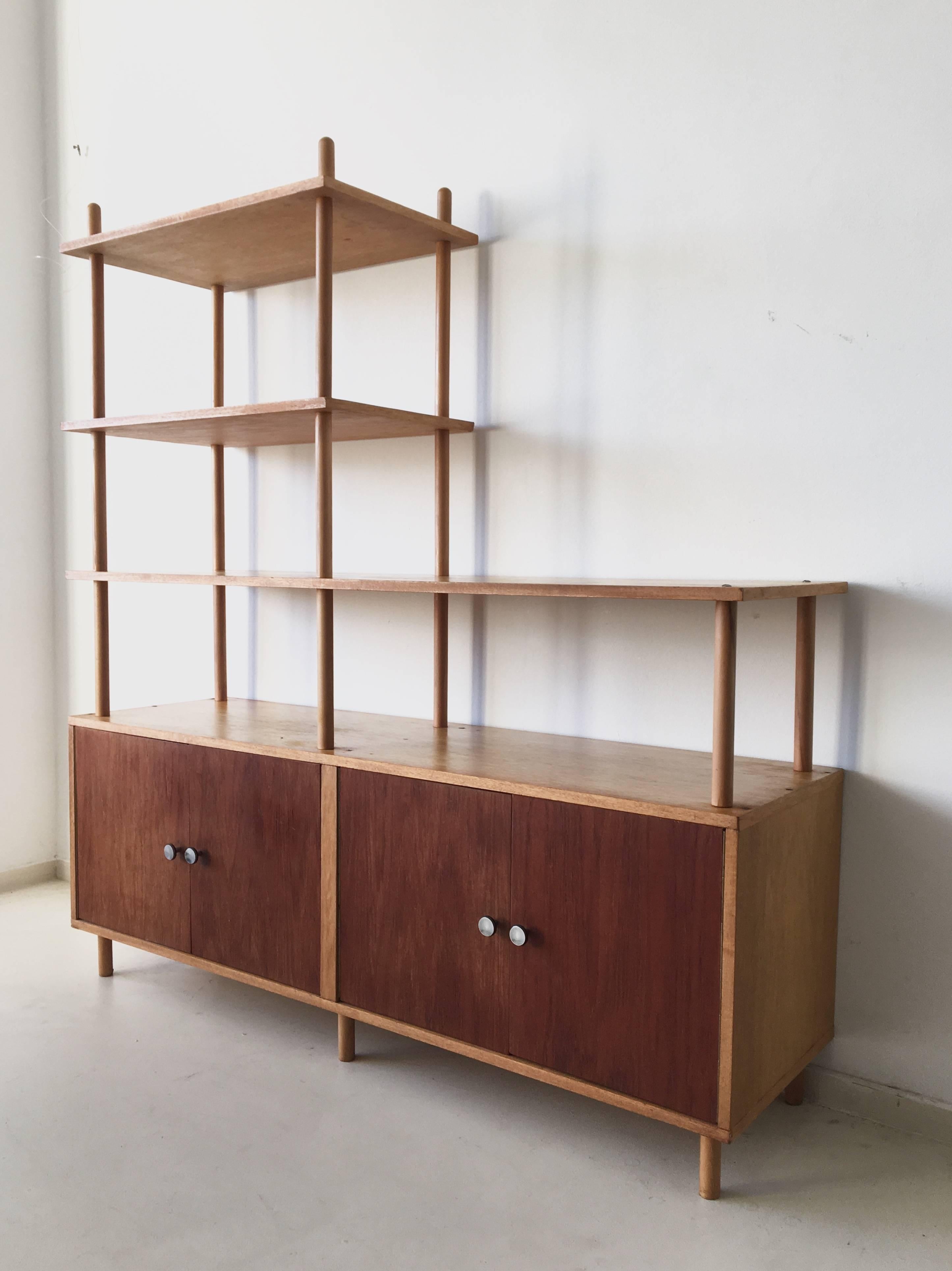 This Midcentury Dutch bookcase was designed by Willem Lutjens for Gouda den Boer, circa 1950-1960s. Inside the cabinet are some non-original shelves, for extra space.

The wall unit is a made to measure type, so extra wall units, cabinets or