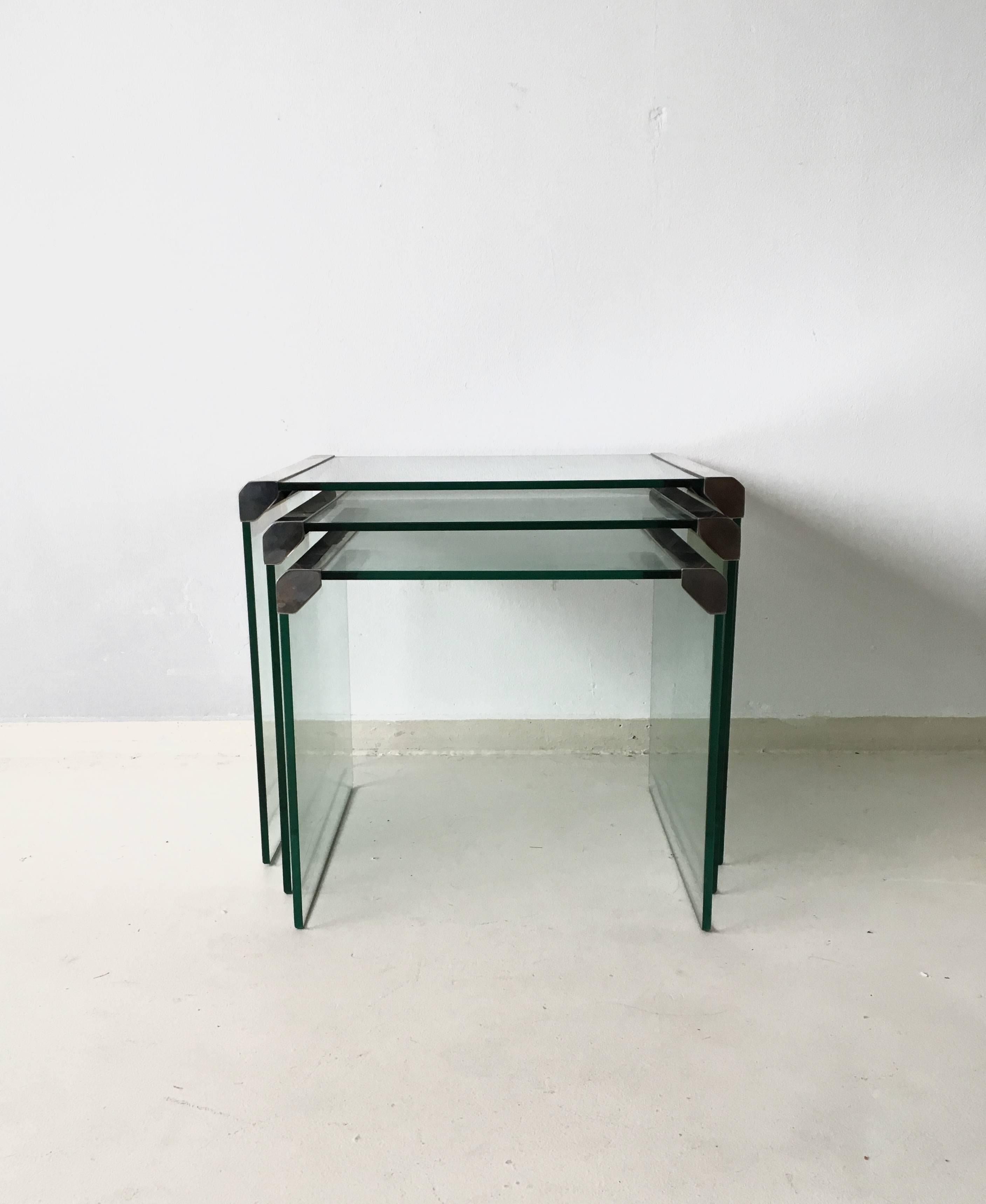 This set of three T35 nesting tables was designed and manufactured by Galotti & Radice Italy in 1975. They consist of 8 mm tempered transparent glass and bright stainless steel metal parts. 

They go well with the Pierangelo Galotti coffee table,