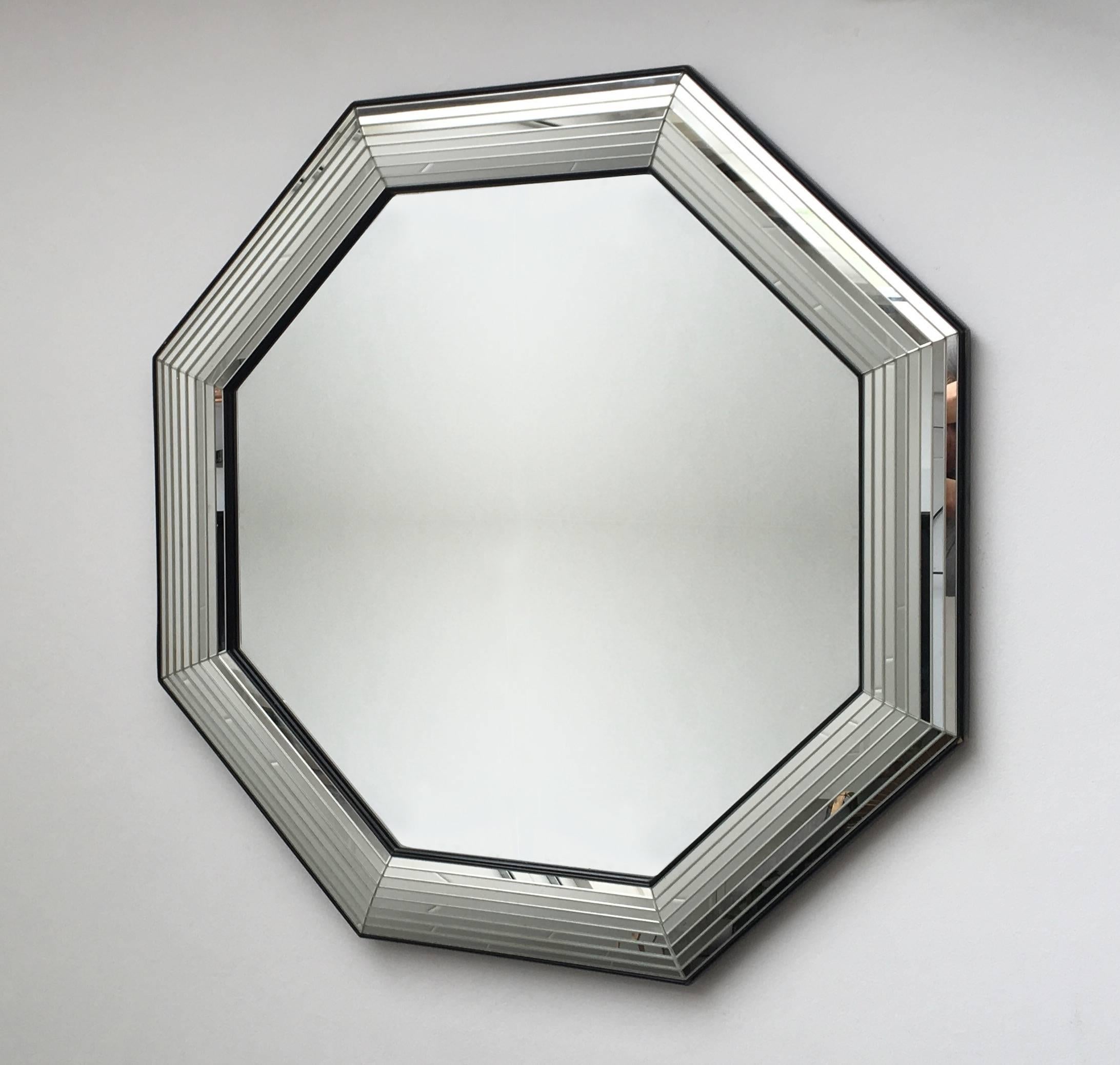 This beautiful designed mirror features a lineal etched mirror border in an octagonal shape. This modern sculptured piece is definitely an eyecatcher which was designed and manufactured in Belgium, circa 1970s. The mirror is very much in style of