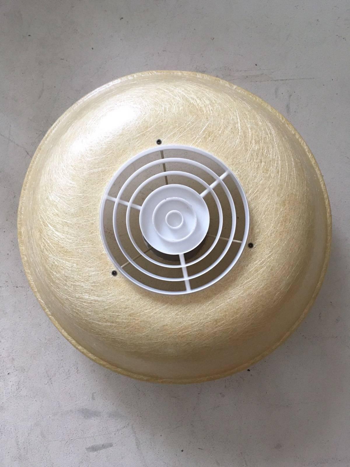 This Industrial model was designed by Louis Kalff for Philips. It was manufactured in the Netherlands, circa 1950s. This piece features a fiberglass shell and light diffusing ring of plastic. The lamp remains in good condition but shows two very