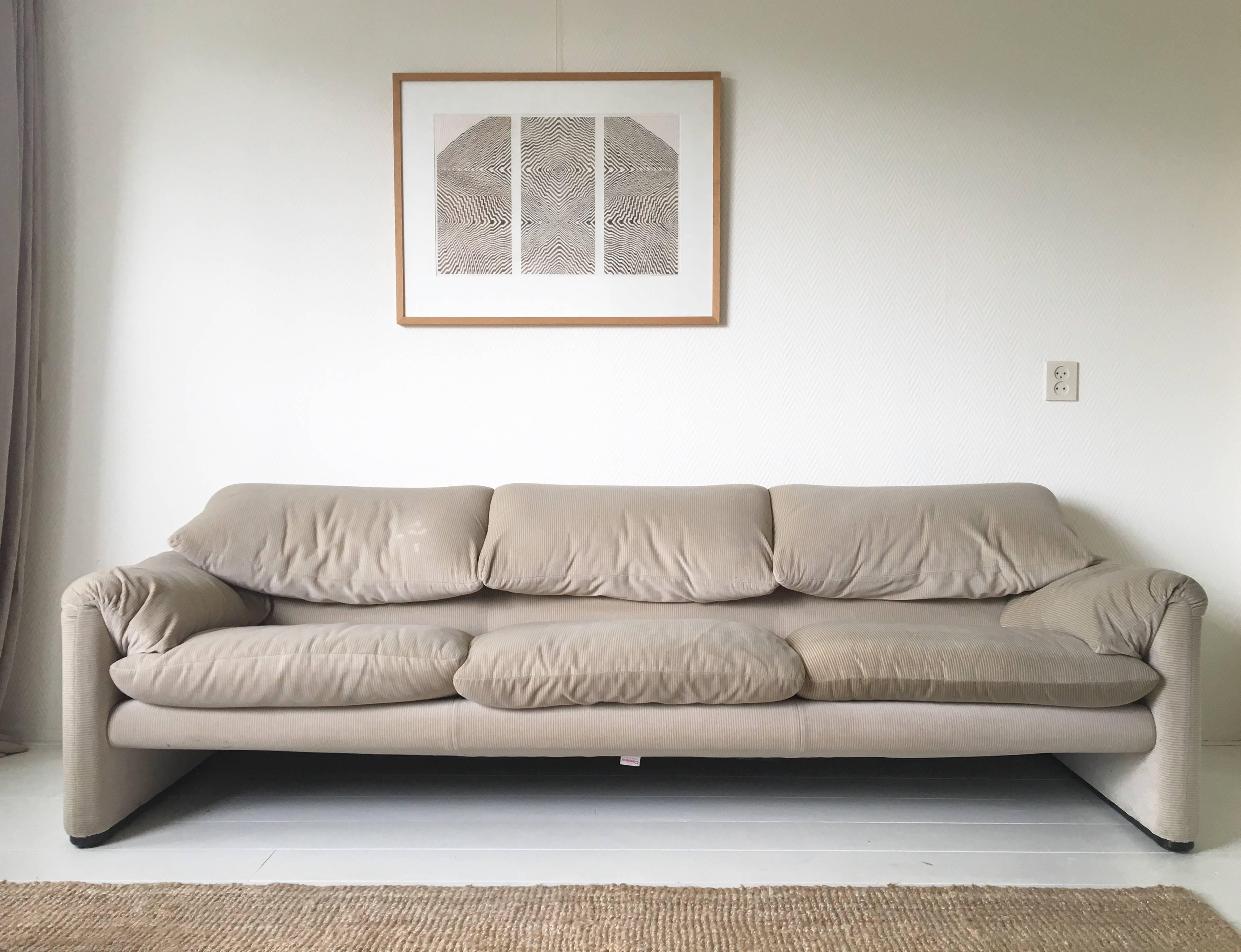 This large, comfortable and timeless sofa was designed by Vico Magistretti for Cassina, circa 1970s. It features a soft fabric with a subtl bi-color stripe pattern. How it's color is exactly to be seen, depends on how the light falls upon it. The