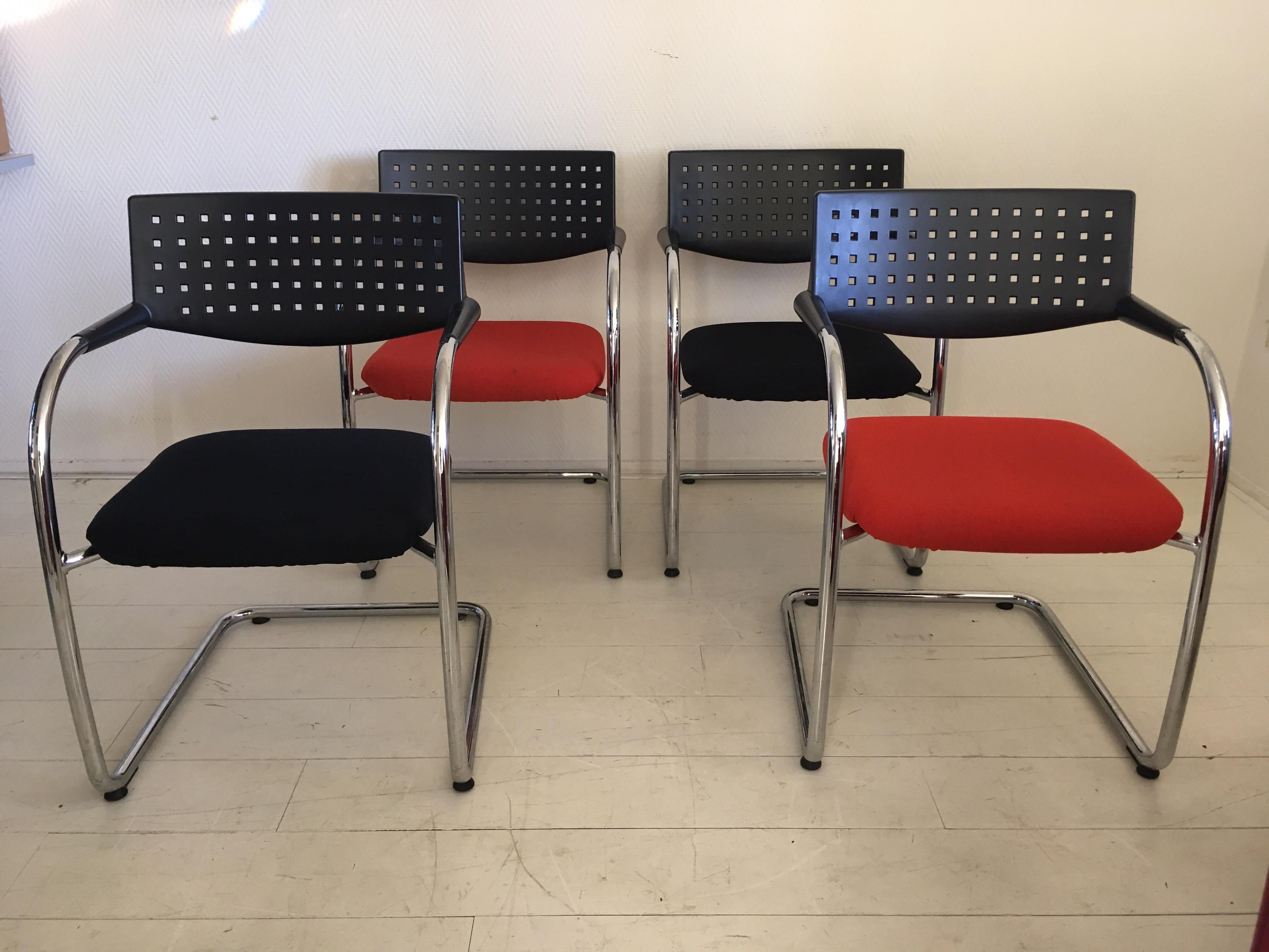 Set of four conference chairs designed by Antonio Citterio and Olivier Low for Vitra. The chairs, which are upholstered in black and red fabric remain in very good condition with some wear to the fabric as stains. They could be cleaned or easily be