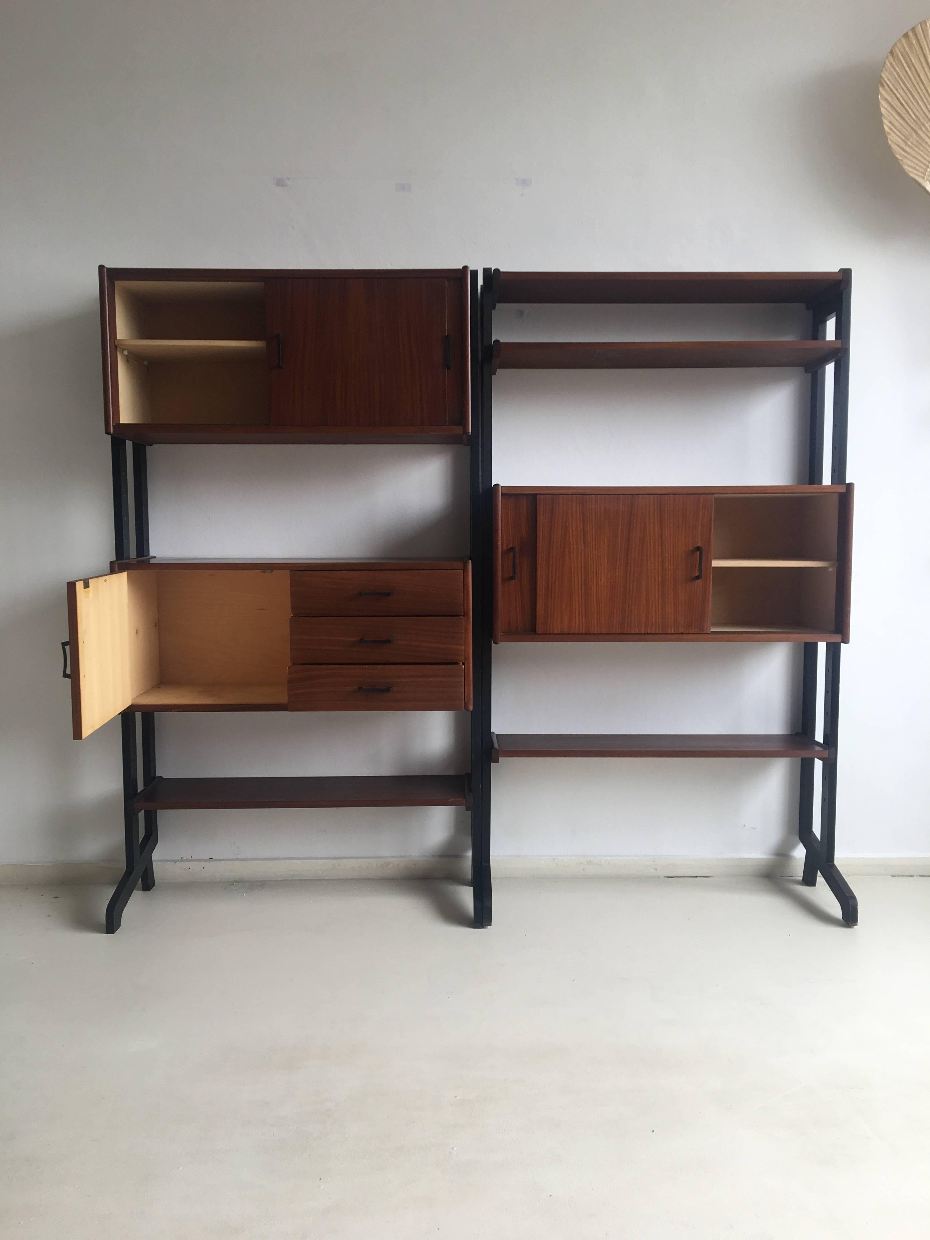 This wall unit was designed and manufactured in the Netherlands, circa1960s. It consists of two separate units in teak, next to each other. The pieces were designed to be adjustable in height and place. 

This wonderful system remains in a very
