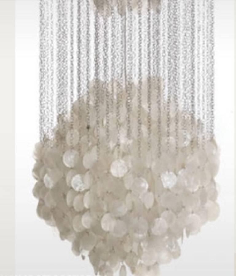 This striking and exclusive 'mother-of-pearl' hanging lamp was designed in 1964 by Verner Panton and by origin Manufactured in Denmark.

This stunning design features three clusters of mother-of-pearl shell discs, attached by long strings of small