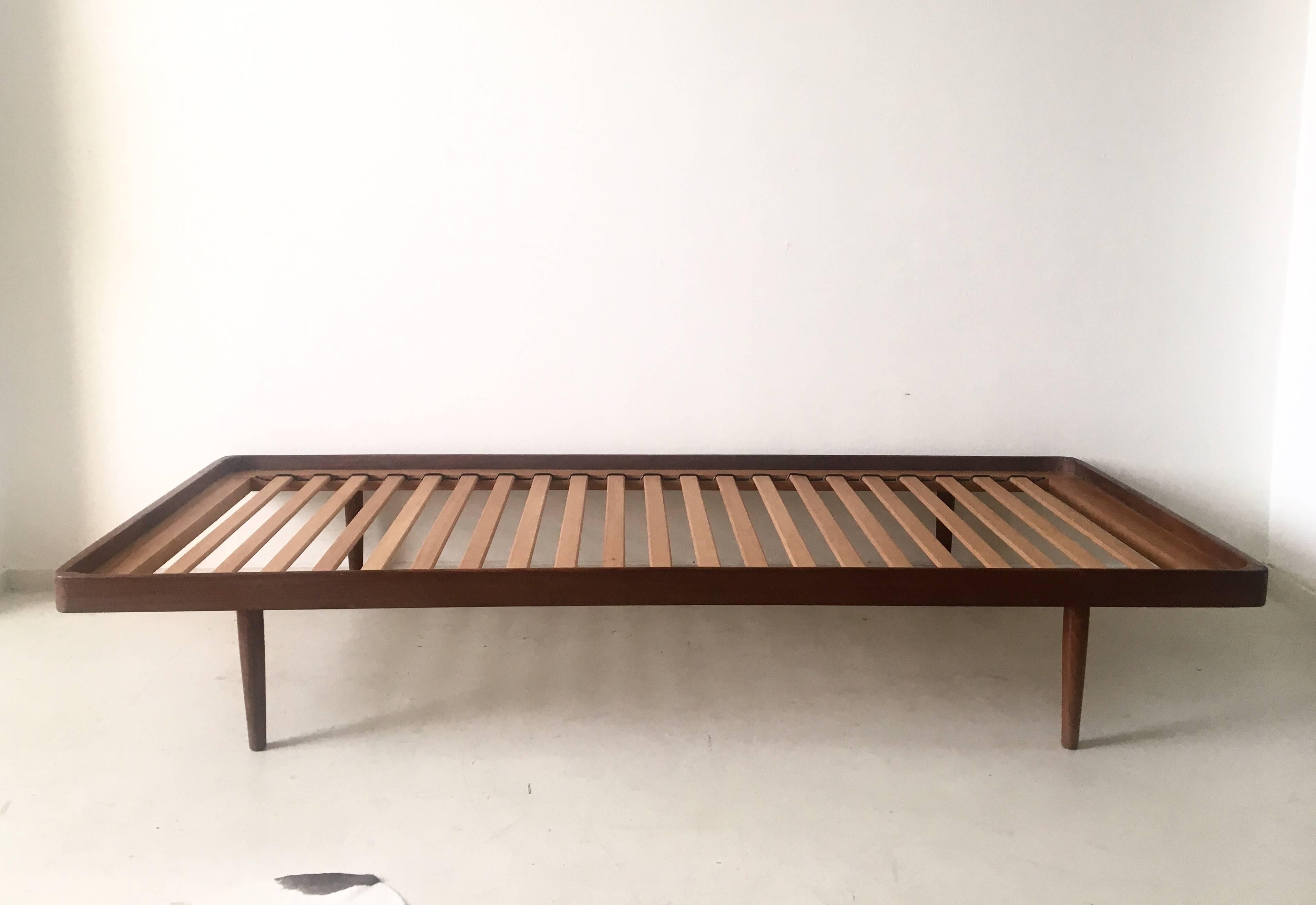 Wonderful daybed that was designed and manufactured in The Netherlands, circa the 1960s. It features a teak frame and an Ochre colored mattress.

This piece remains in good vintage condition with some wear, consistent with age and use. One small