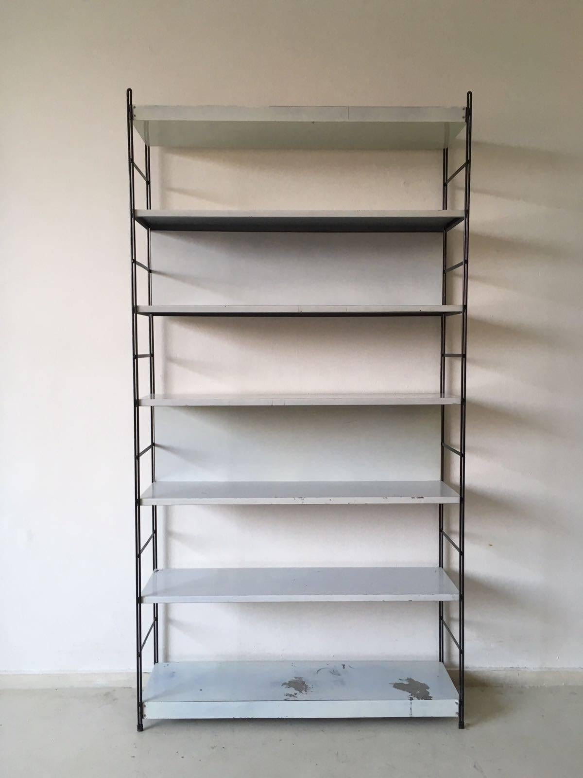 This minimalistic freestanding rack was designed and manufactured in The Netherlands circa 1960s. It resembles models of Pilastro, Tomado, Drentea.
Two of the shelves feature a metal back which is also to be seen often with pieces by Friso Kramer.