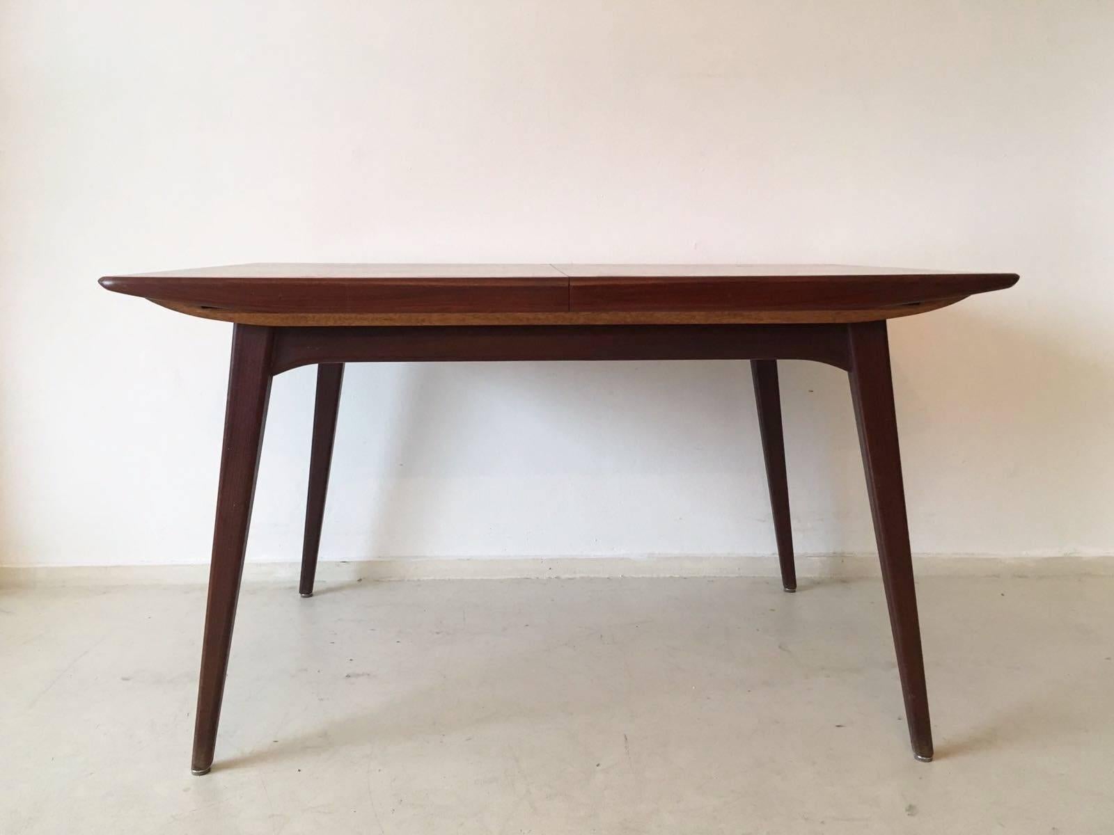 This beautiful Dutch design dining table was manufactured in the Netherlands, circa 1960s. It features a body and legs made from teak. The table remains in a very good condition, with some signs of age and use (see images). Measures: Extendable to