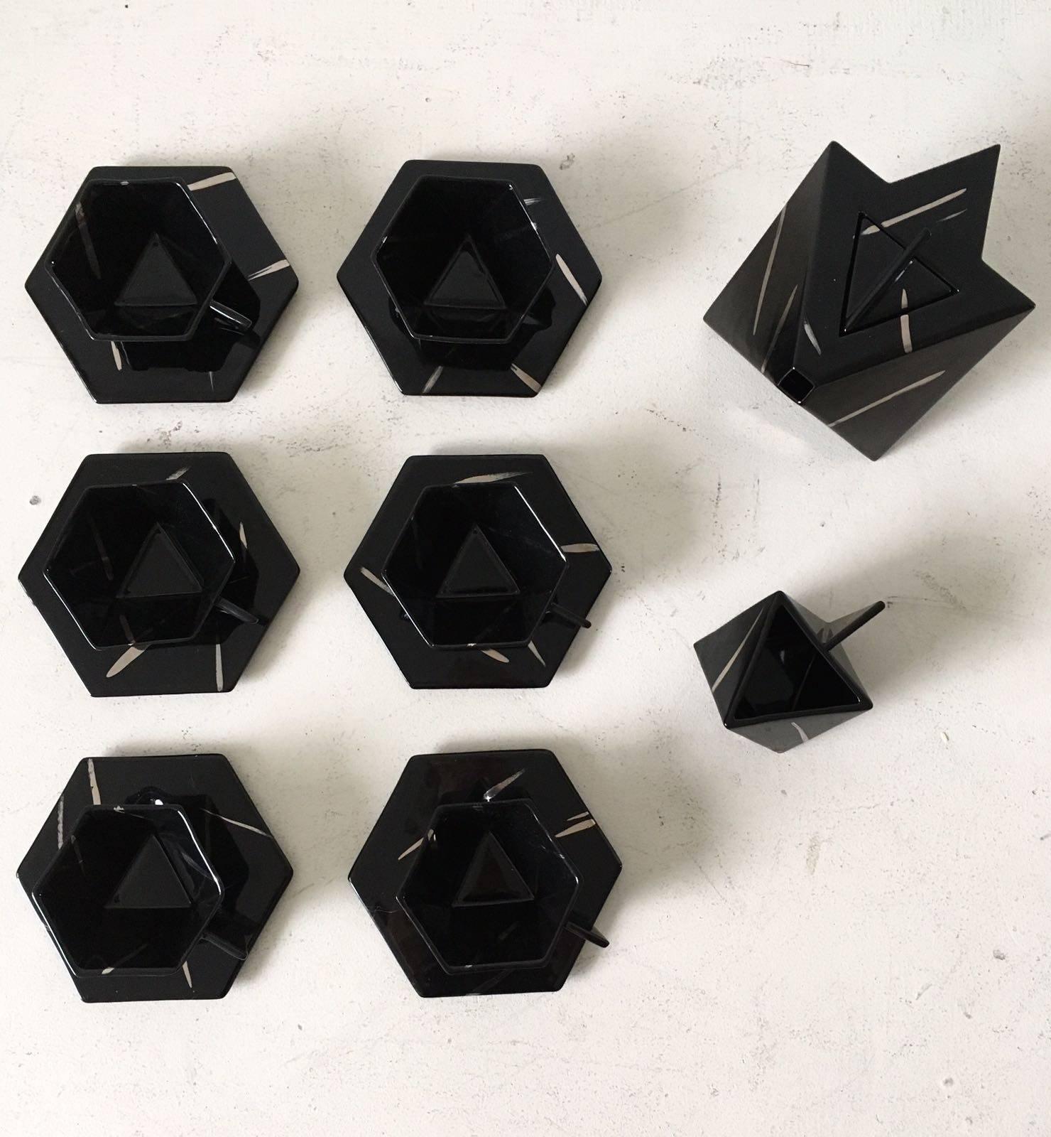This stunning and rare Hexagonal tea service, unfortunately unsigned, was most likely designed and manufactured in Sweden by Rolf Sinnemark for Rorstrand. This glazed porcelain or stoneware set features Hexagonal and Triangular forms which gives