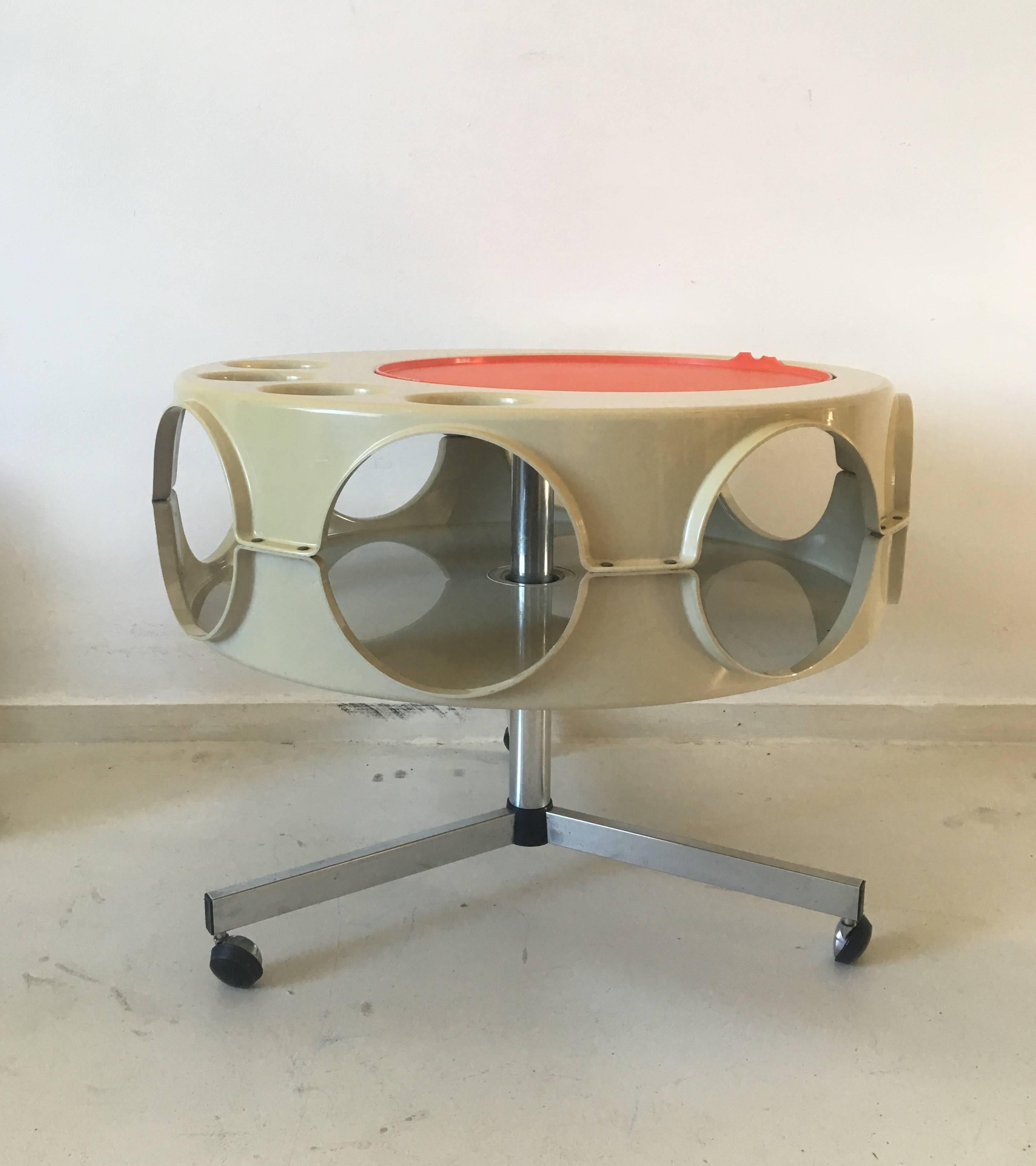 This stunning pop art era, bar table or bar cart was designed and manufactured in the Netherlands in the 1970s.
It features a Chromed metal base on wheels so that the trolley can serve you anywhere in and around the house. Its body made of ABS