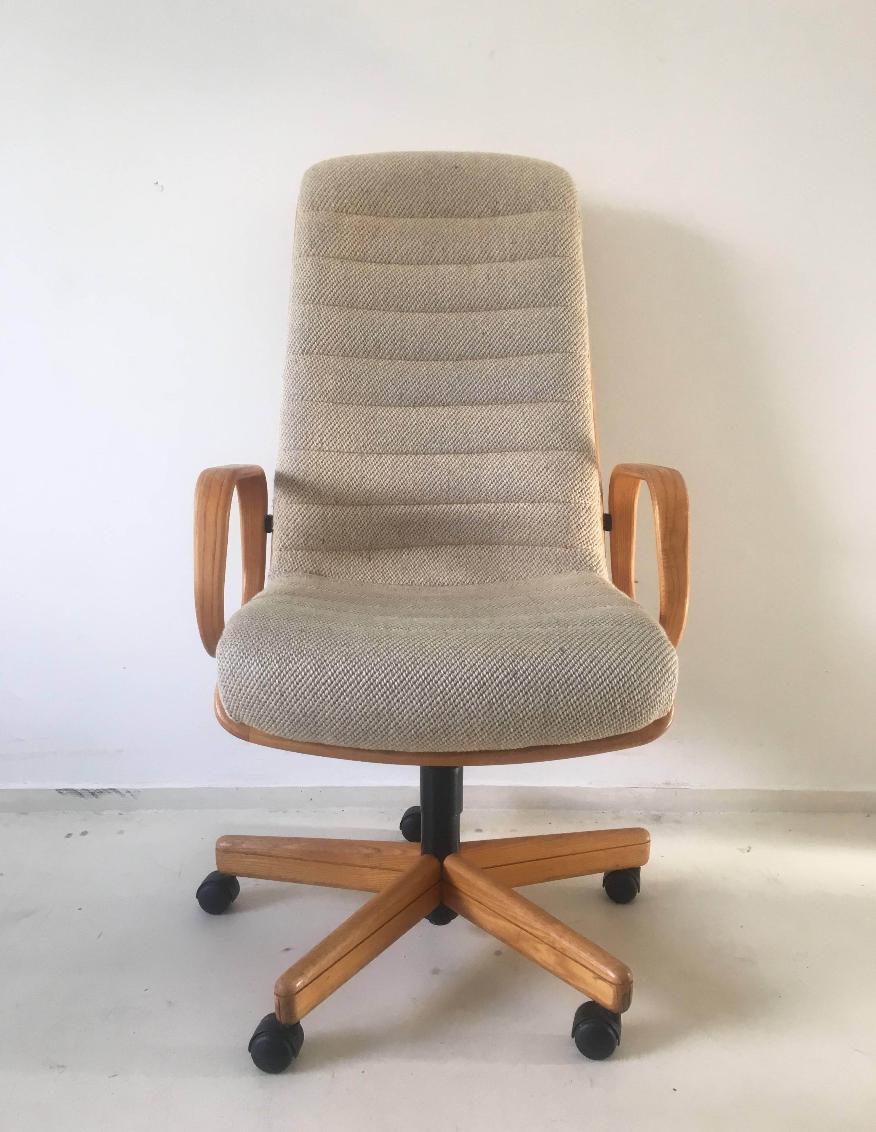 Absolutely wonderful design, which was given the purpose to have a natural look and comfort. 
The chair features a massive oak frame and five star base. It was upholstered with basic colored wool. 
This exclusive chair can be adjusted in height