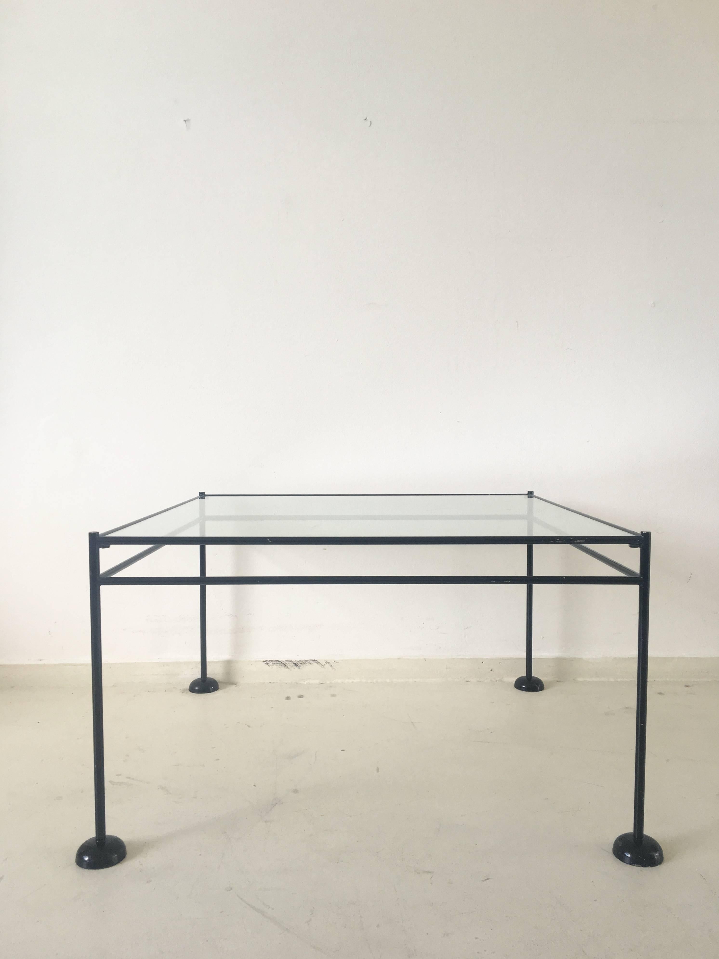 Wonderful Minimalist coffee table with a black lacquered metal base, round metal feet and a glass tabletop.
The table remains in good solid condition but shows some scratches to the glass and some wear to the paint of its frame.
When an Industrial