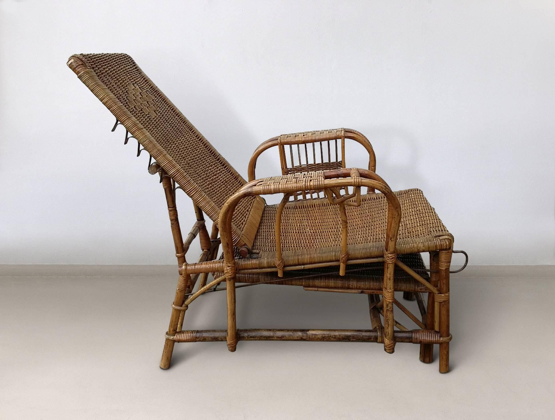 This deck chair was designed and manufactured in Europe, circa 1930s-1940s. The backrest can be adjusted in five positions and the chair features a foot stool and a cup holder in one of the armrests. The other armrest had been adjusted by hand by