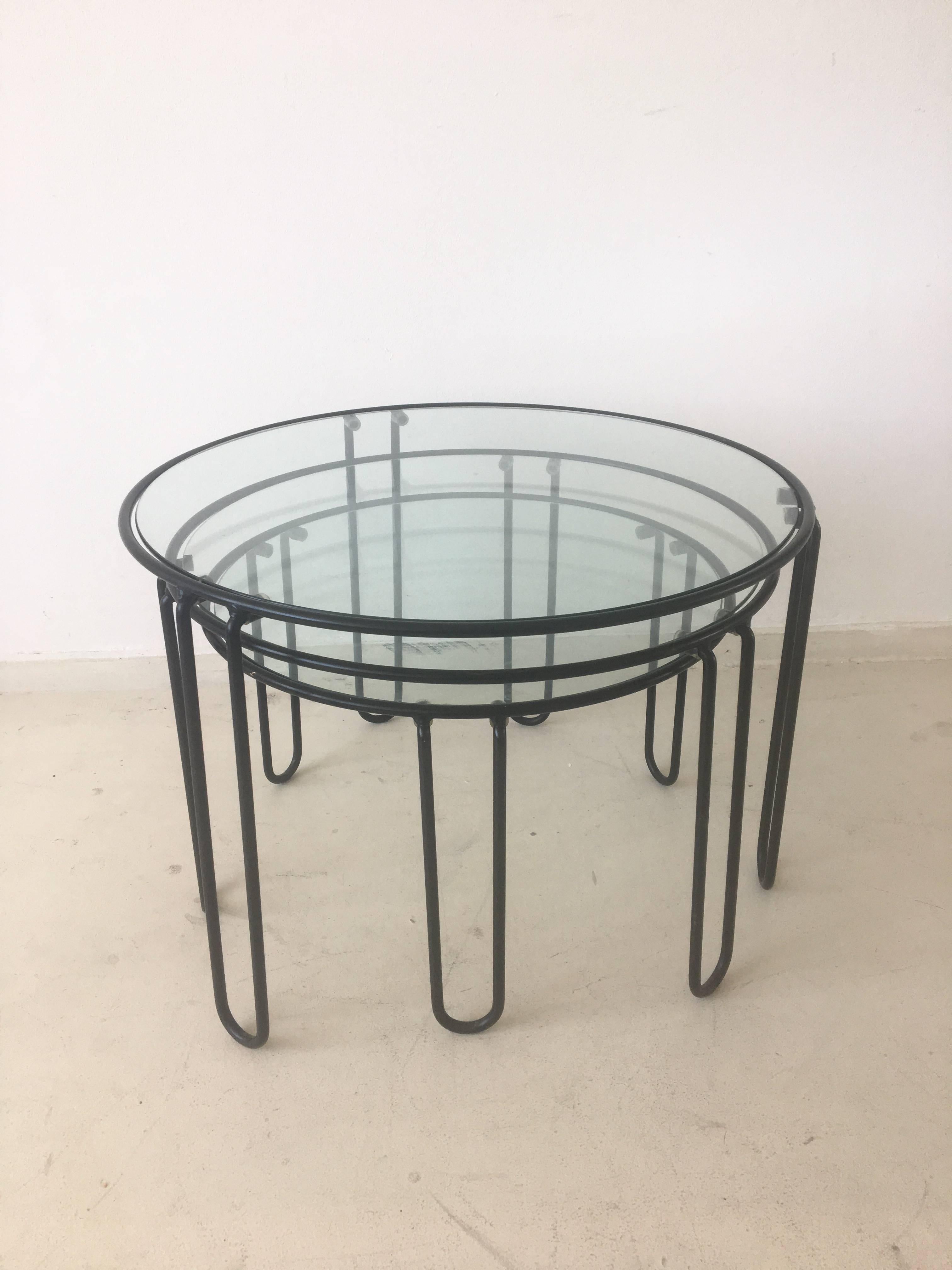These coffee tables are stackable but can also be used next to each other. Some resemblance with designs of Arnold Buena de Mesquita and Sapority. They feature a black metal frame with a glass top. They remain in good condition with some signs of