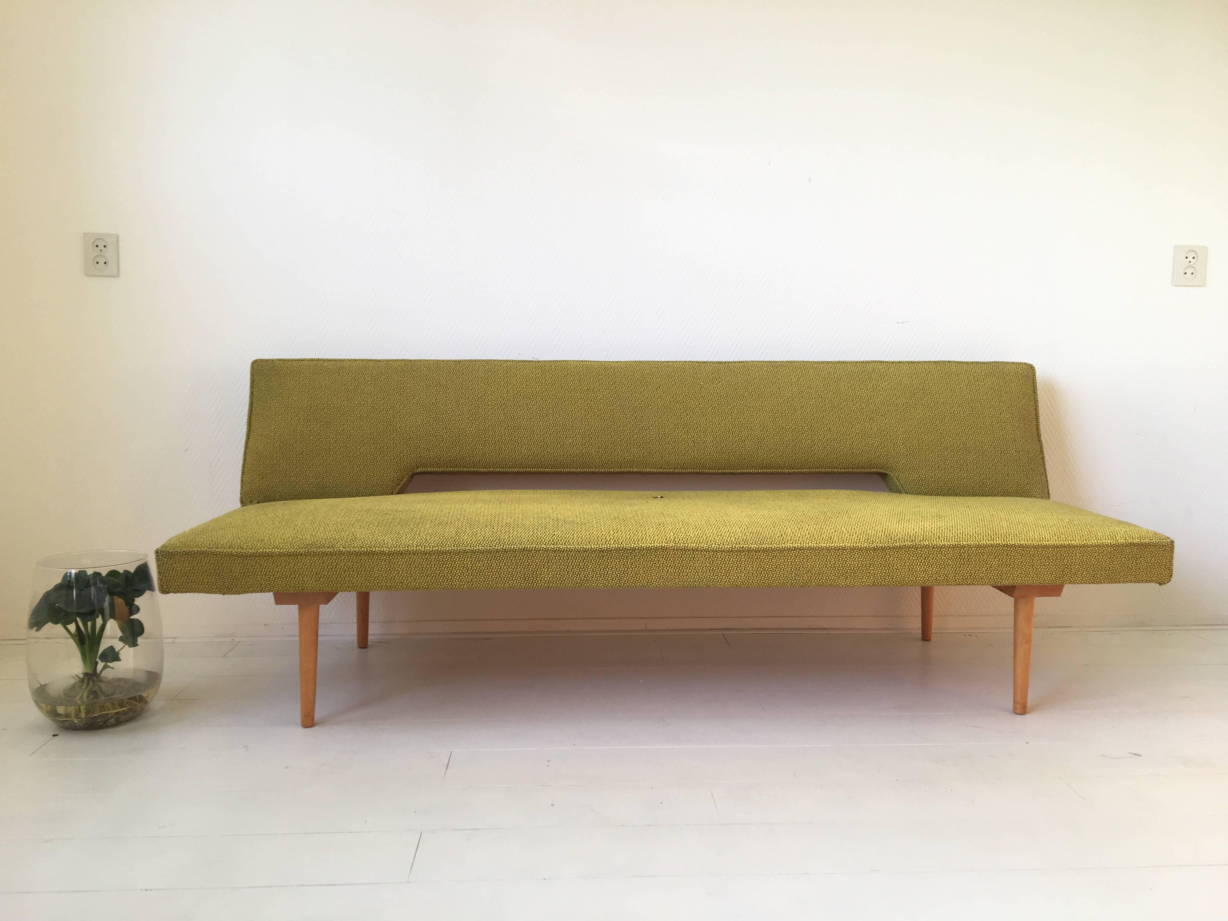 Wonderful Mid-Century Modern sofa, designed by Miroslav Navratil, circa 1960s. This simple sofa can easily be changed into a bed. The sofa features a beech frame with still the original yellow and black fabric. Timeless design with some wear to the