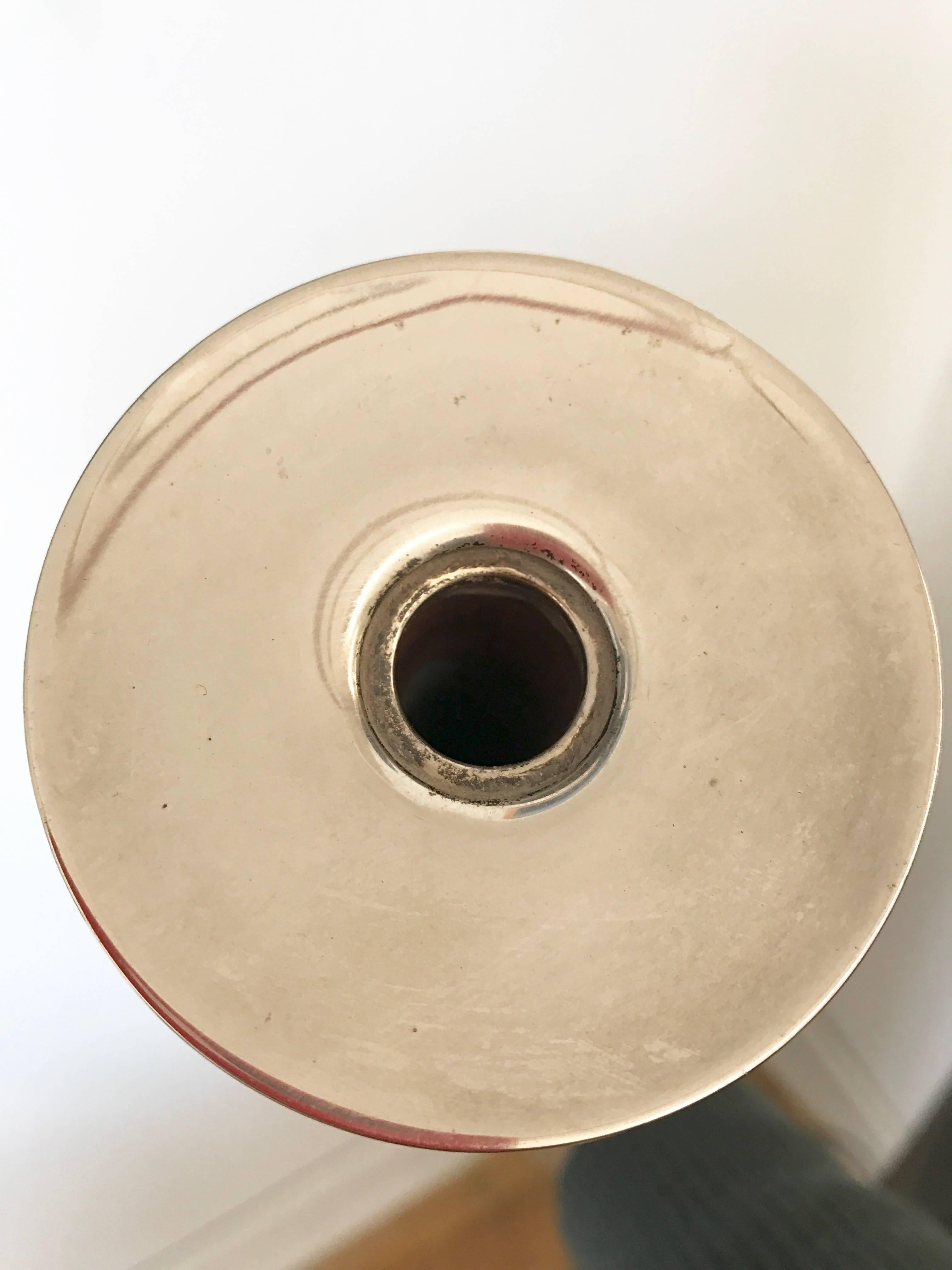 Silver plated candleholder by Lino Sabattini.
From Reggio Emilia, Italy, Sabattini worked with Gio Ponti and many other architects and designers. He mastered the crafts thanks to influences by Ponti and Rolando Hettner. a pottery maker from