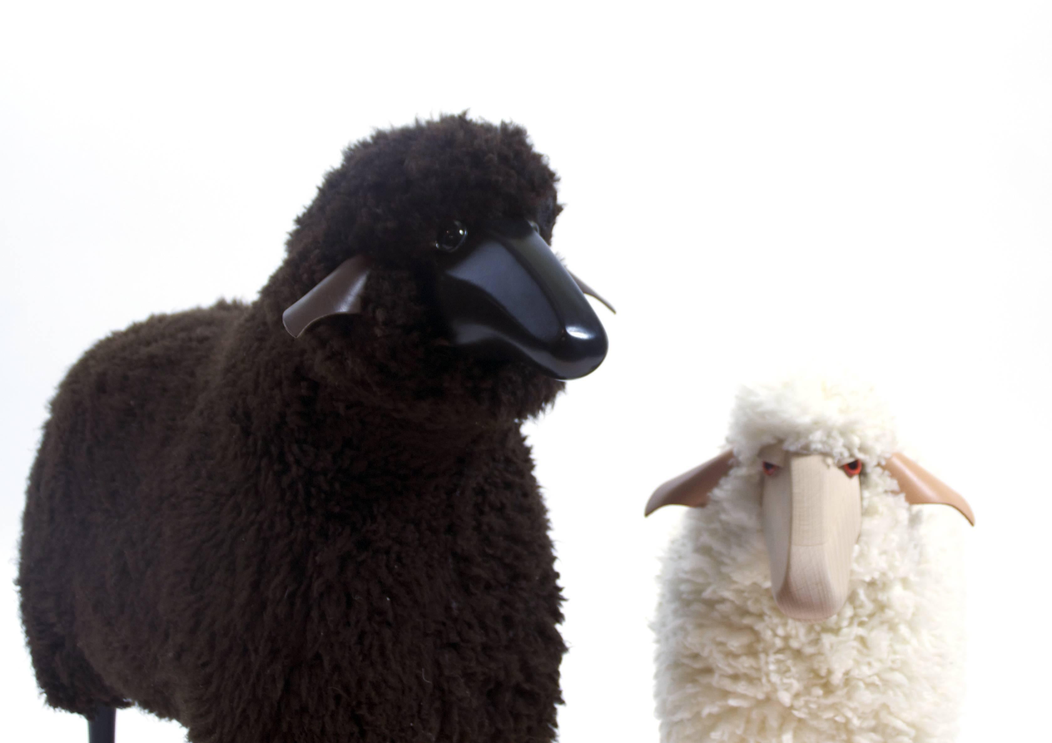 Vintage decorative sheeps sculptures in the style of Claude and Francois-Xavier Lalanne. 
The two sheeps are made in leather (ears), glass (eyes) genuine wool (body), sculpted wood for the feet.
 