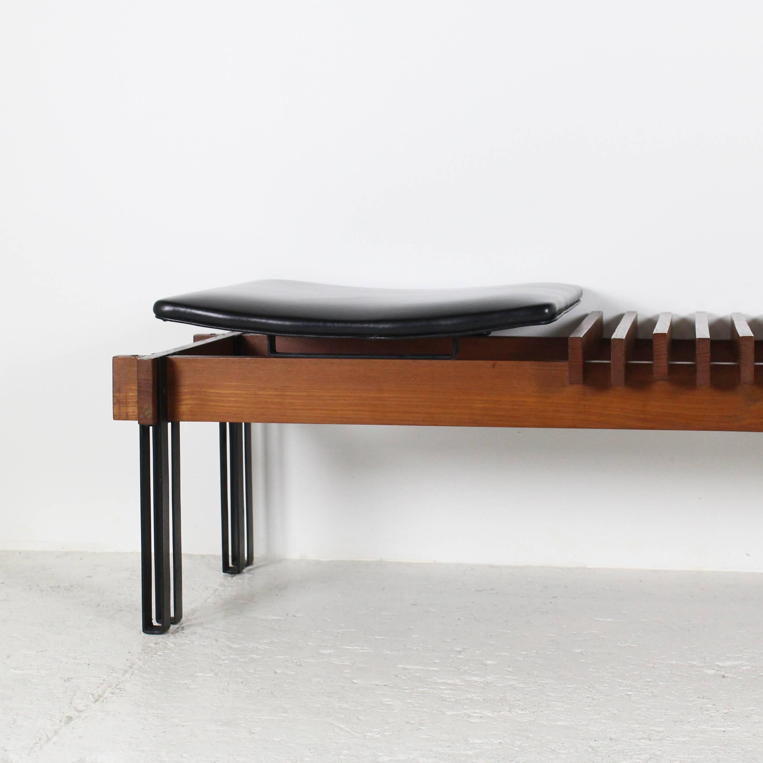 Mid-Century bench in teak on black metal legs with black leatherette seat, designed by Inge and Luciano Rubino, published on 1964 (R. ALOI, L'Arredamento Moderno). 
Measures:
Depth: 40 cm / 15.74 inches.
Seat height: 36 cm / 14.17 inches.
Width: