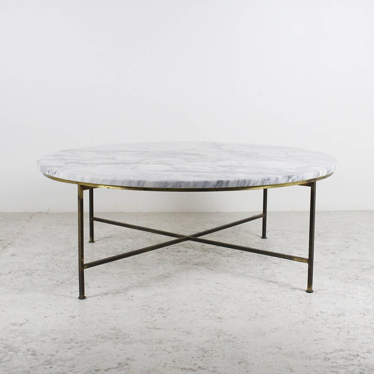 1954 round coffee table by Paul McCobb, manufactured by Directional. 
Marble top, frame in golden brass. 
Similar model in: LINDBECK Jennifer, "1950s furniture by Paul McCobb: Directional Designs," ed. Schiffer Book, USA.

Measures: