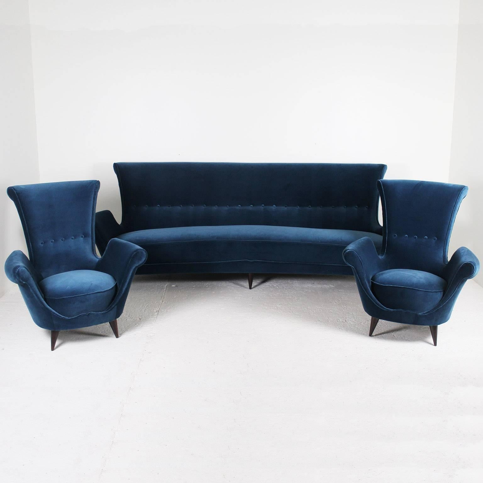 Splendid 1950s sofa and pair of armchairs, newly reupholstered in a blue velvet fabric by Maison Elitis, hand-stitched piping. The armchairs dimensions are:
Depth 80 cm, width 82 cm, height 90 cm, seat height 42 cm.