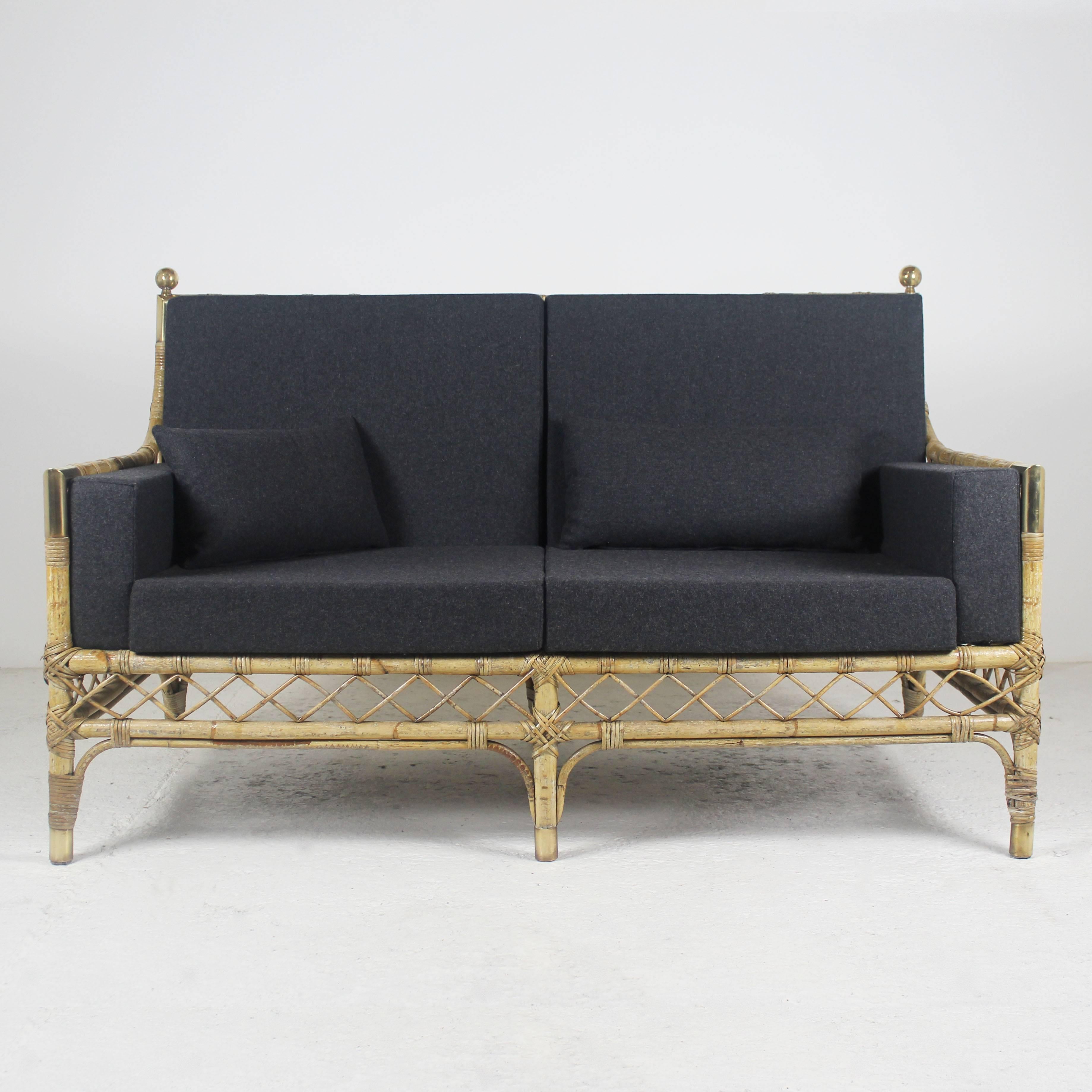 A 1960s sofa in bamboo, rattan and golden brass. Removable covers’ cushions in a totally redone charcoal grey fabric.