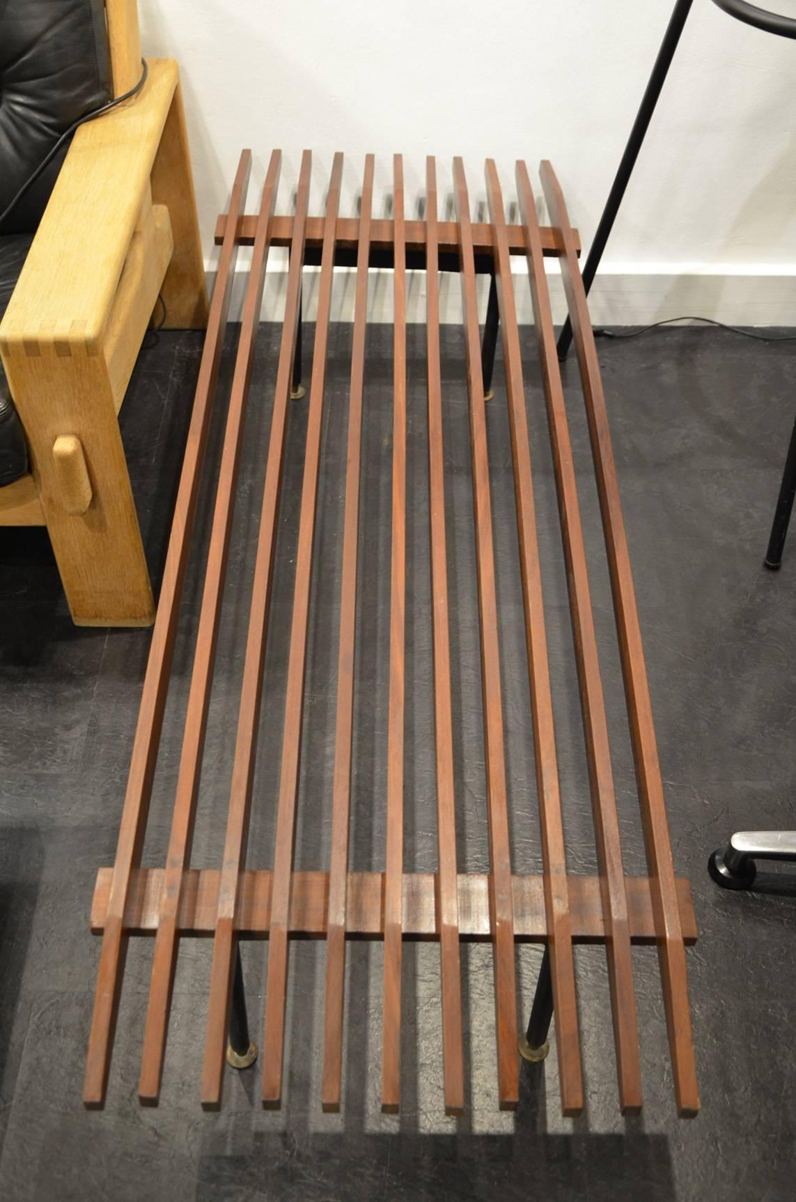Beautiful 1960 wood and brass Italian bench.
This Italian slatted wenge bench with a black metal frame and brass details was made in the 1960s. It can also be used as a side table or coffee table.
Good vintage condition.