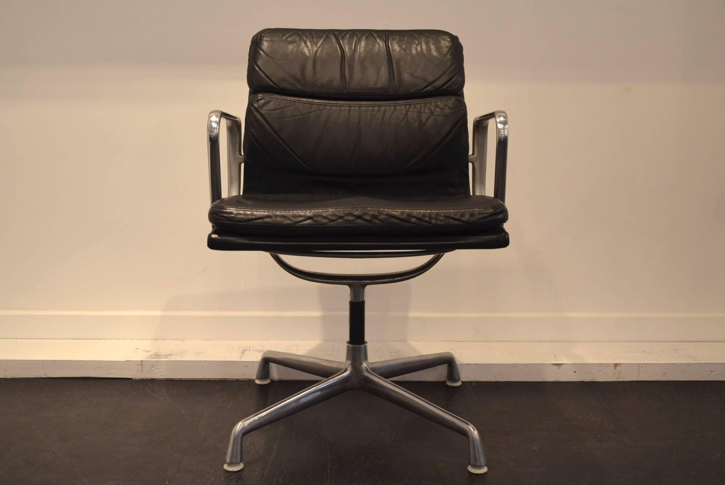 Black soft pad chairs model EA 208 designed by Charles and Ray Eames for Vitra, 1960s. The seats are padded in their original soft black leather, on a cast aluminium frame with plated chrome and a four-star base. Marked with label and stamped frame.