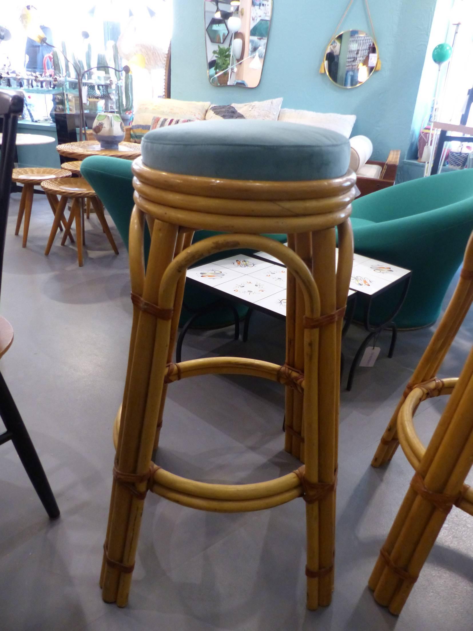 Beautiful pair of reupholstered wicker bar stools, circa 1960. Excellent condition.