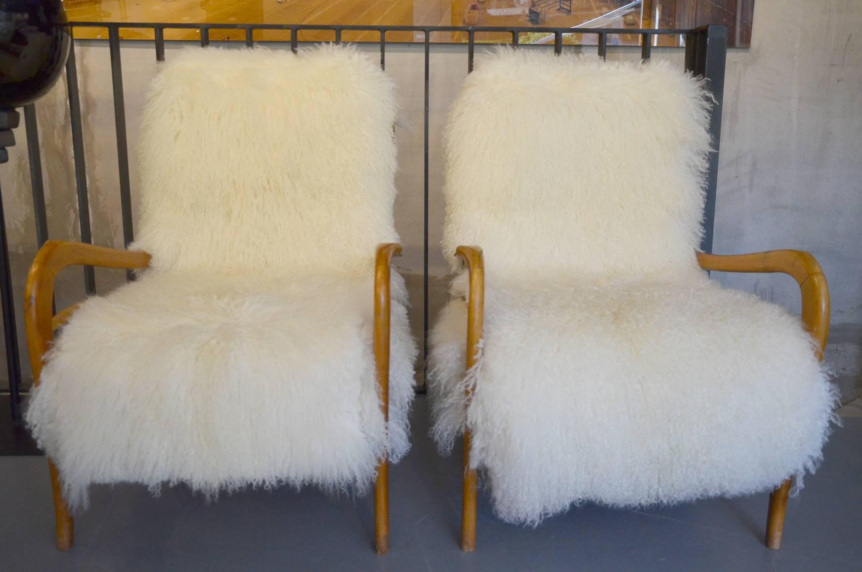 Beautiful pair of reupholstered armchairs attributed to Gio Ponti, circa 1960. Reupholstered in a Tibet lamb fur.