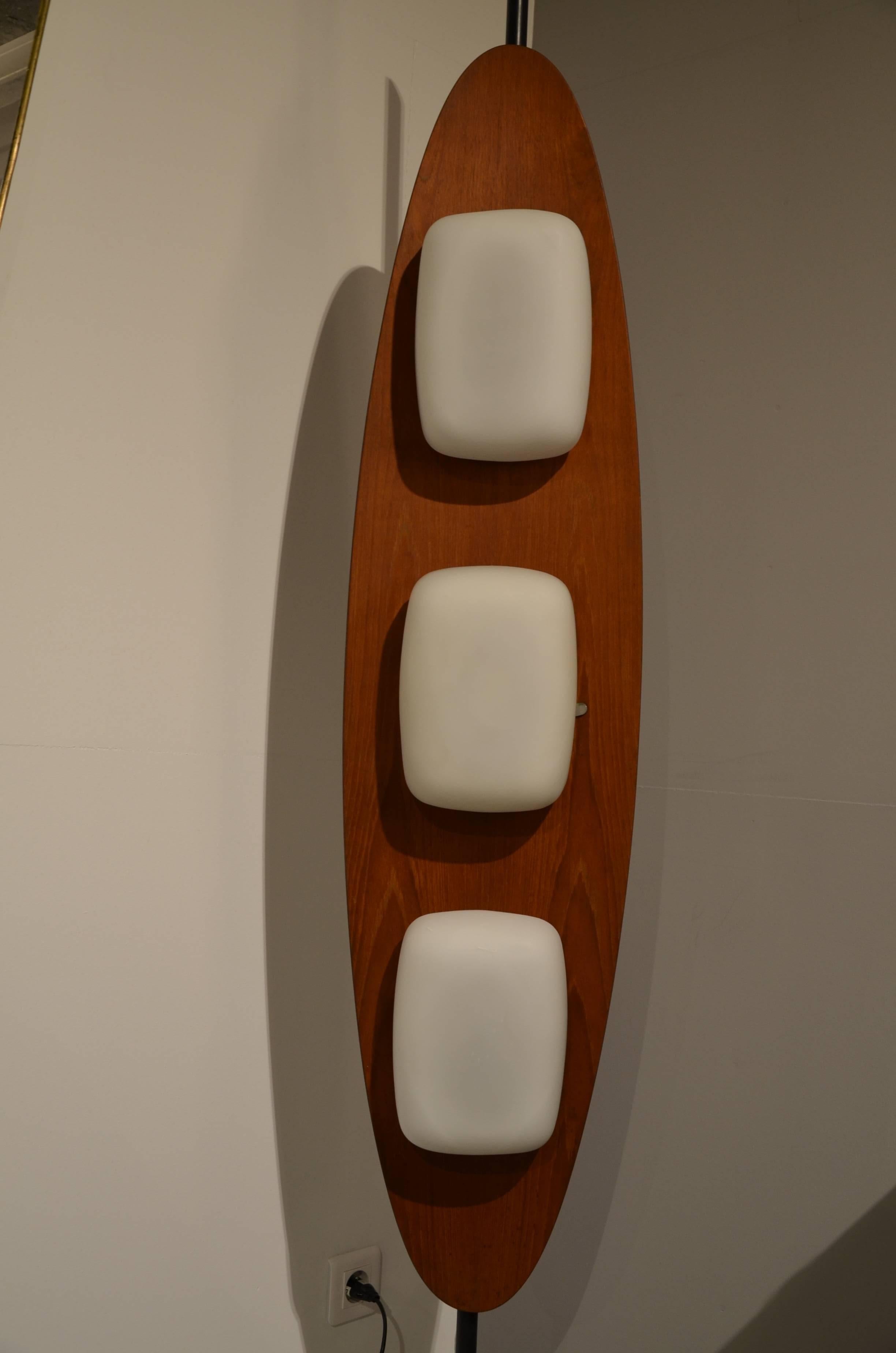 Italian floor lamp by Reggiani, circa 1960 on a round white marble disk. The oval mahogany structure with three white opaque glass bodies is mounted on a blackend iron rod.

Excellent condition.