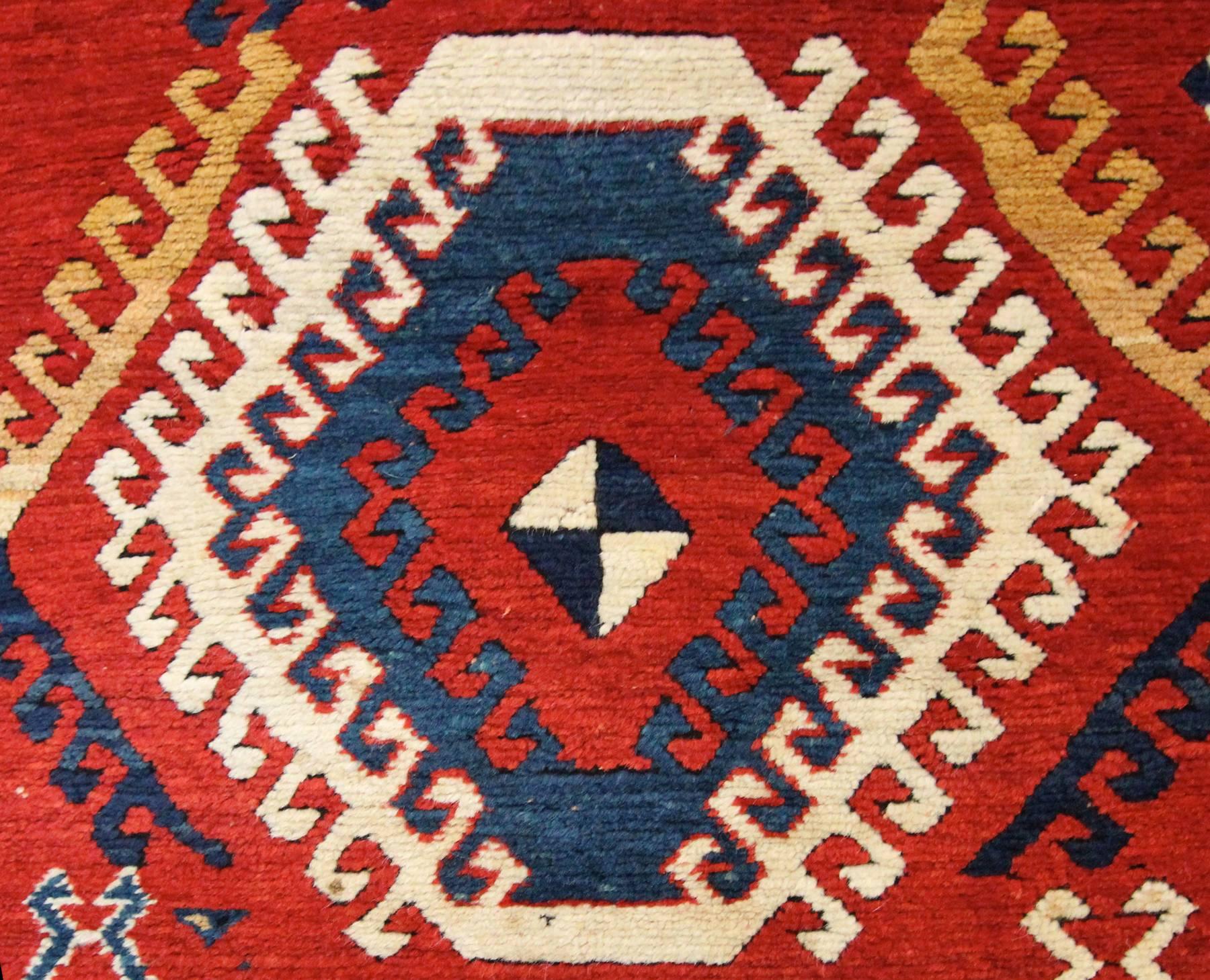 A beautiful full pile antique Borjalou Kazak rug woven in the last 1/4 of the 19th century in remarkable original condition. These type of rugs from the Caucasus always have a striking latch-hook zig-zag border, along with the same repeating motif