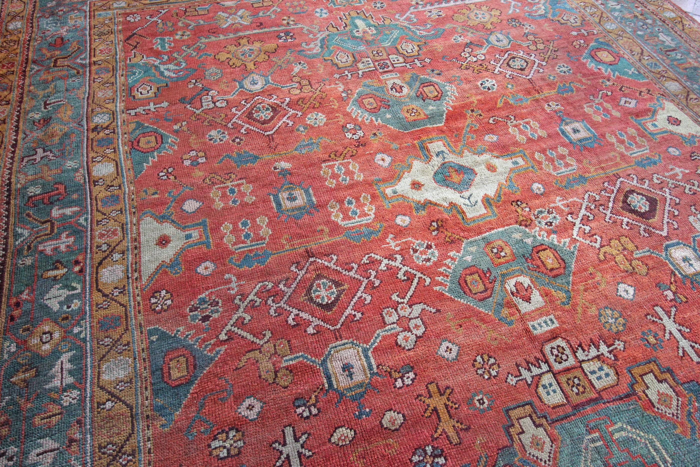 This antique Ushak carpet has been woven with a beautiful variety of greens and soft red/terracotta tones that have mellowed to soft colours due to the carpets age. Created around 1890-1900 for a carpet that is 120 years old it is in excellent