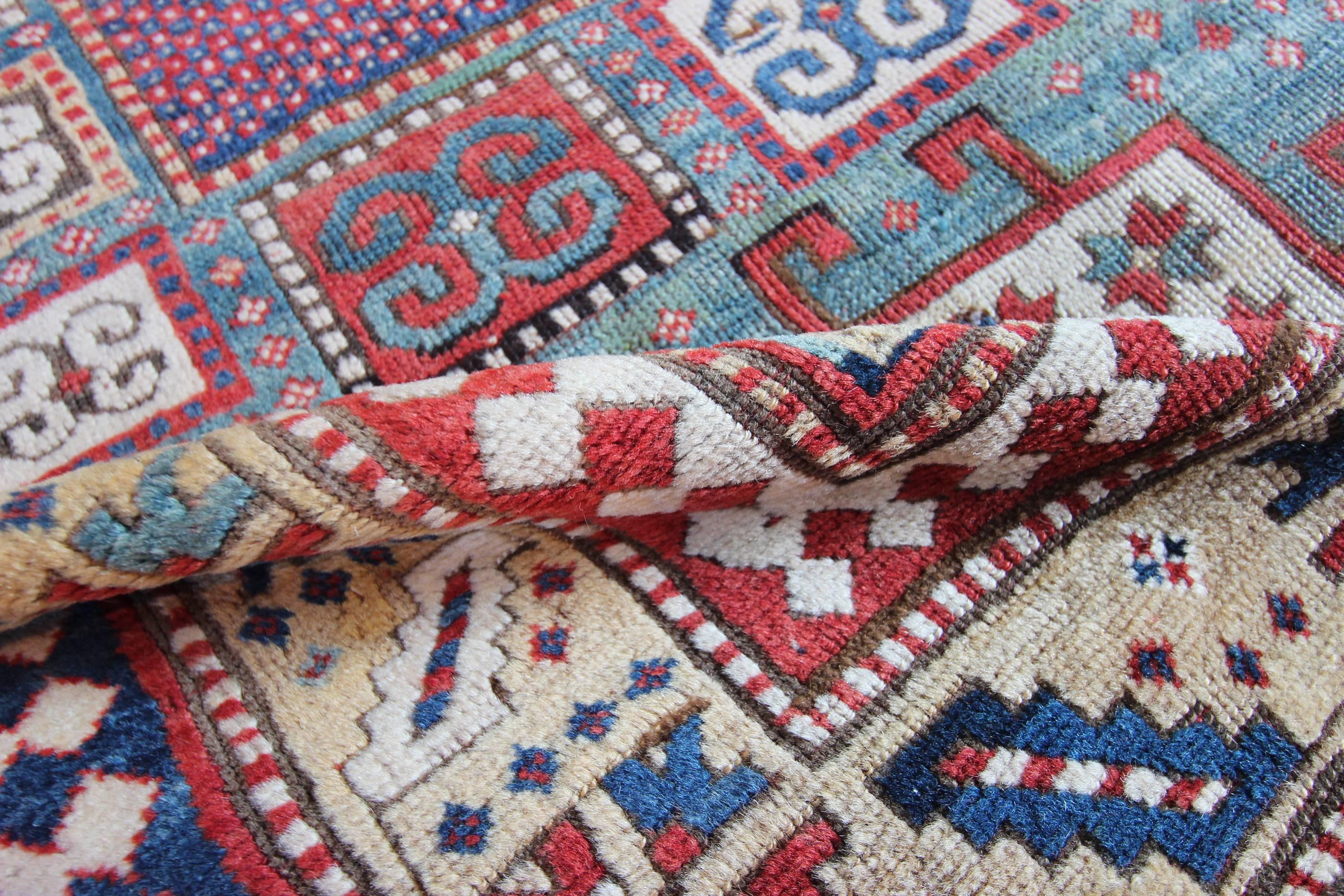 A bold and vivid antique Karachov Kazak rug woven in the Caucasus mountains in Azerbaijan by Armenian weavers. Also known as "Karachopf" these tribal weavings were made using soft wool on a woollen foundation, giving them a light feel to