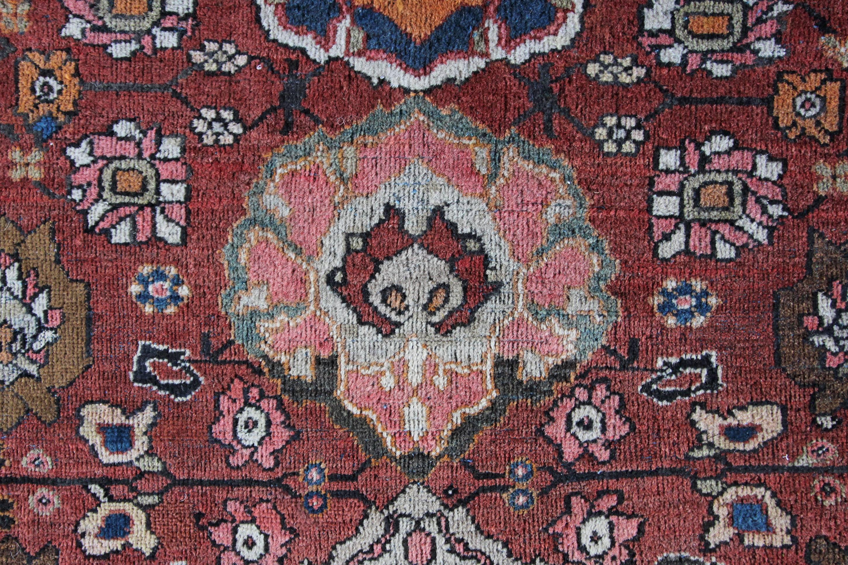 A beautiful unusual square antique Mahal carpet with muted colors in good condition and large floral palmette designs. The colors are varied, from soft greens and muted brown red dyes to the sludgy greens and indigo blues. We do see some synthetic