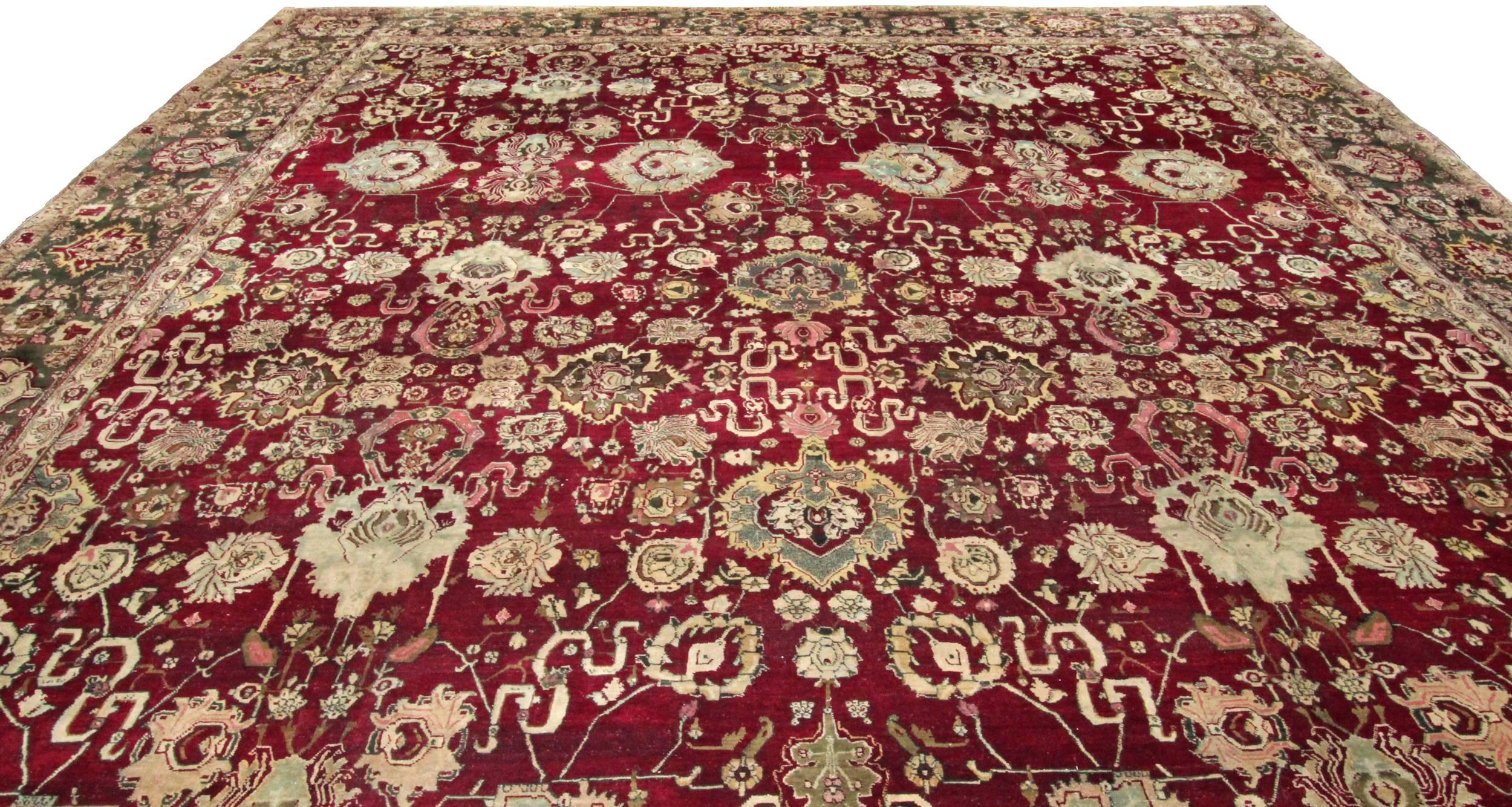 An extremely rare large antique Agra carpet in remarkable condition. Woven with a deep burgundy background and a rare green border. A truly magnificent carpet woven in Agra in India around 1870. The brown dye on this carpet has corroded showing an