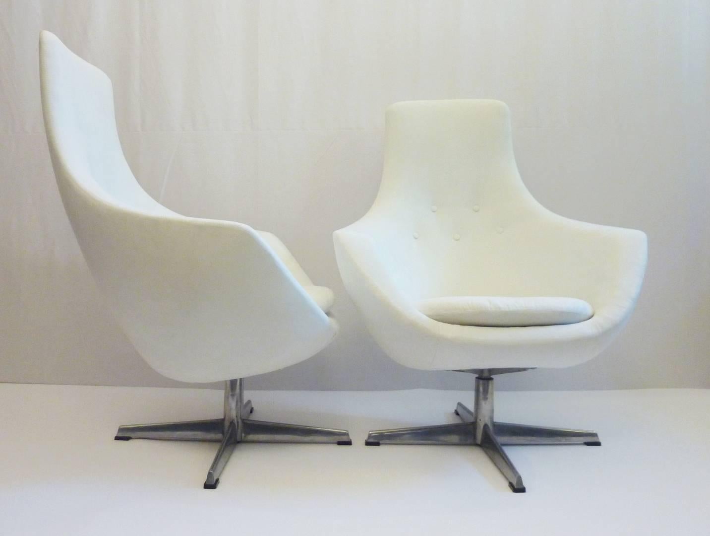 A pair of comfortable armchairs recently reupholstered in white faux suede. The swivel mechanism works excellent and the chair in itself is super lightweight.