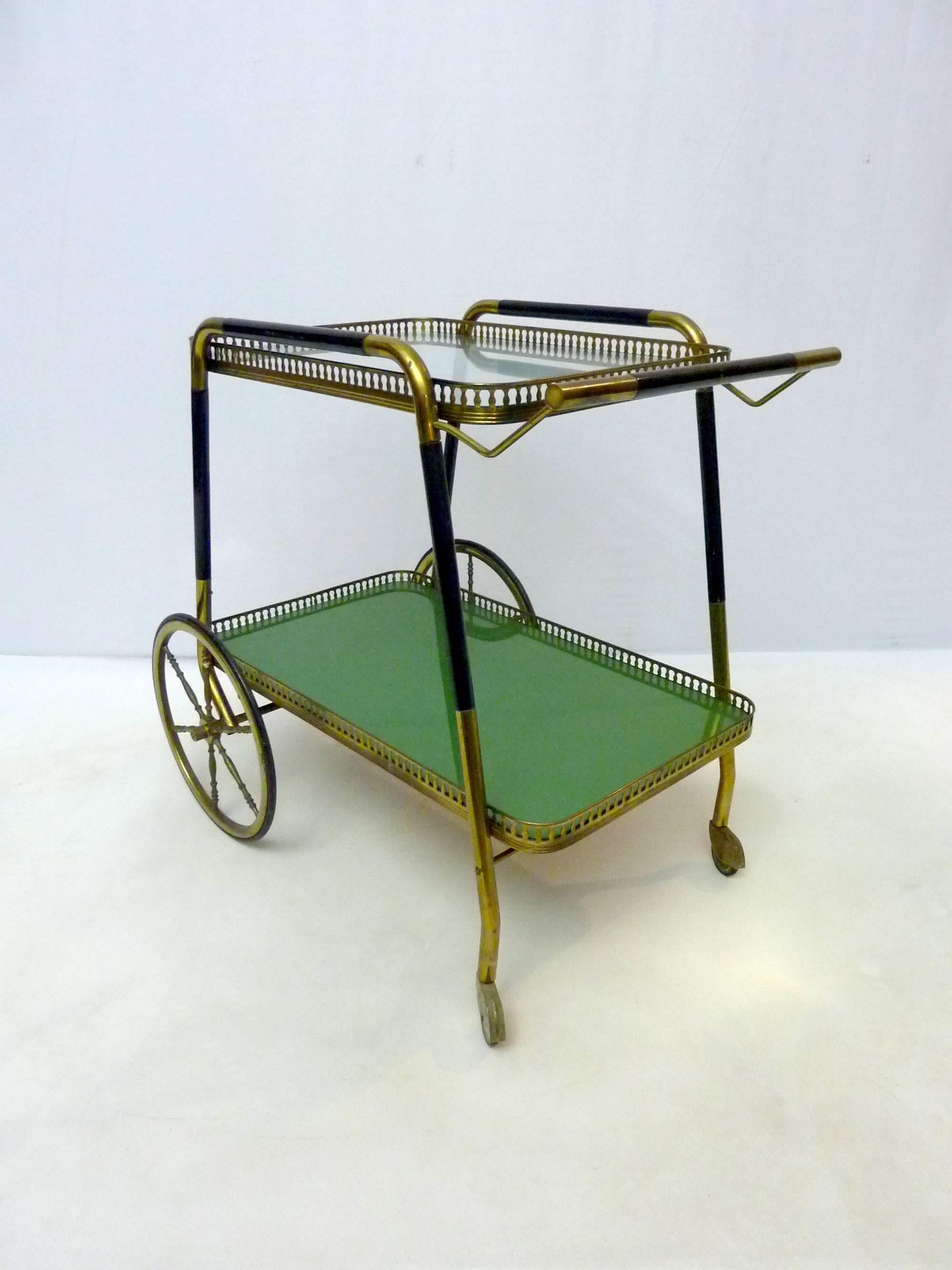 Classic Cesare Lacca two-tiered bar trolley. The bottom shelf has a glass with a green layer underneath and the top is clear.