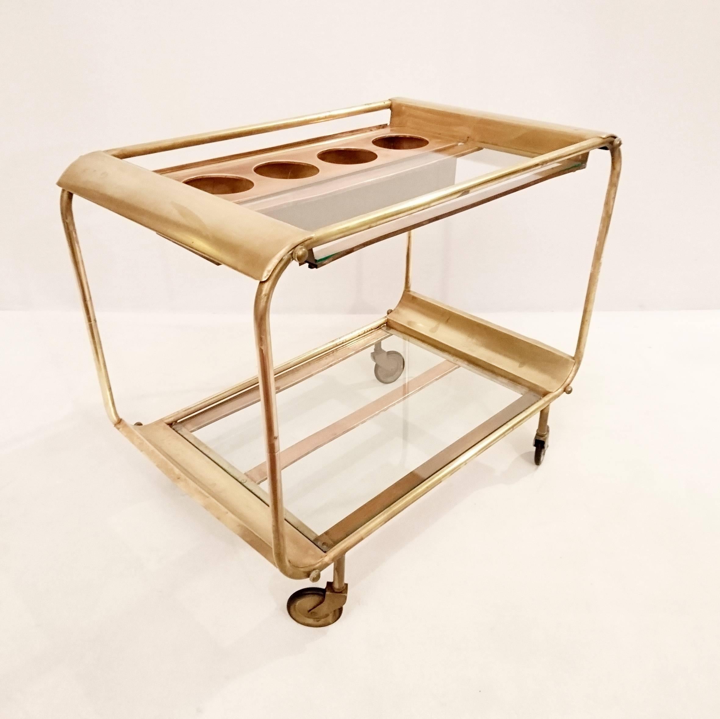 Unique and beautiful trolley from the late 1920s or early 1930s in distinct Art Deco style clearly reminiscent of Bauhaus. Made in both copper, brass and glass with a bottle holder on top with room for four bottles.