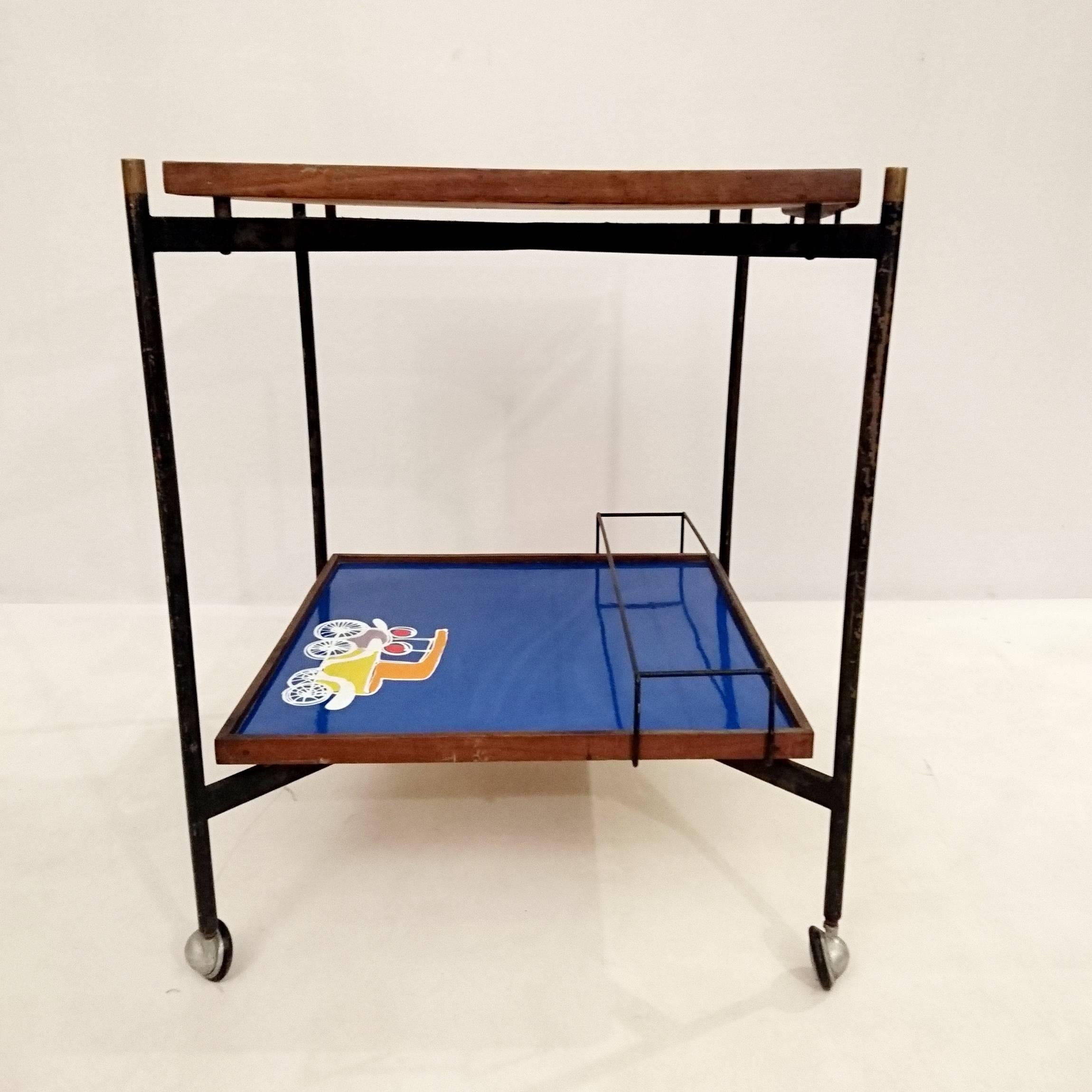 Trolley with two tiers in blue and white with painted car motifs. Frame in iron with brass details and teak surrounding the levels and handle.