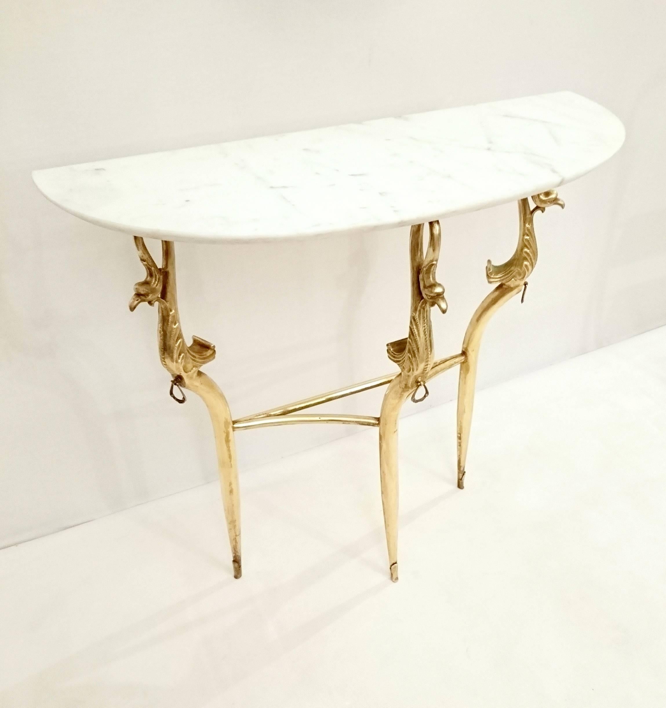 Italian console table in carrara marble and brass made in the 1950s in empire style with an oval mirror. The mirror measures 78x50 cm