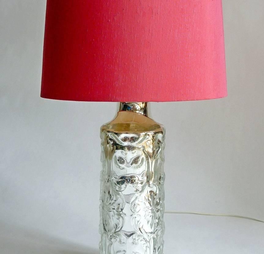 1960s table lamp by Swedish glassmaker Orrefors in silver colored glass attributed to Gustav Leek. Comes with original dupion silk shade in pink.