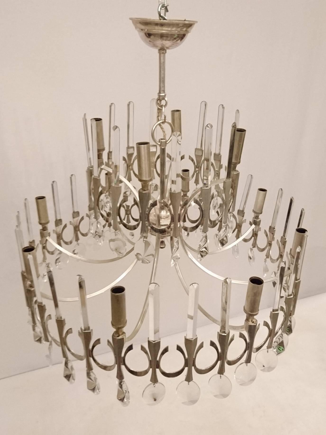 Large Classic chandelier design by Gaetano Sciolari with crystal prisms with a satin finish on the metal. It has a total of 12 lights, eight at the bottom and four on top. Carries 12 standard small screw standard light bulbs (E17) up to 40 watts